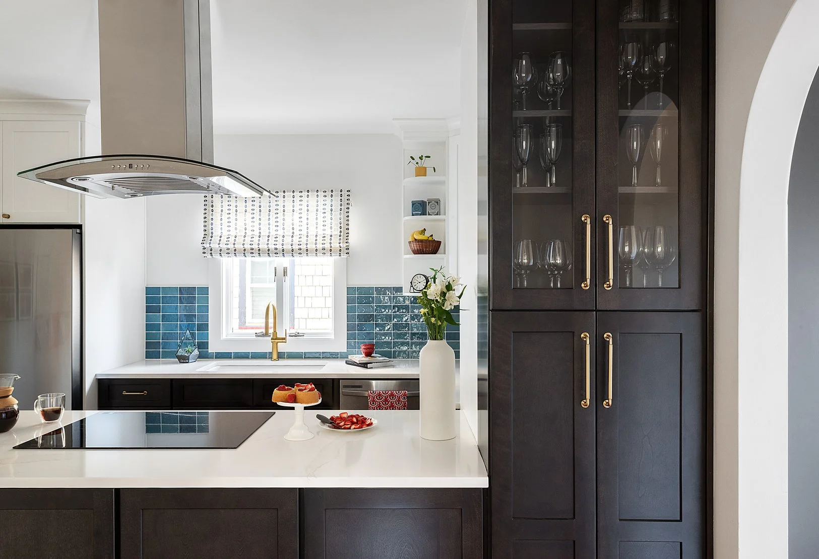 Dark wood pantry cabinet with glassware.