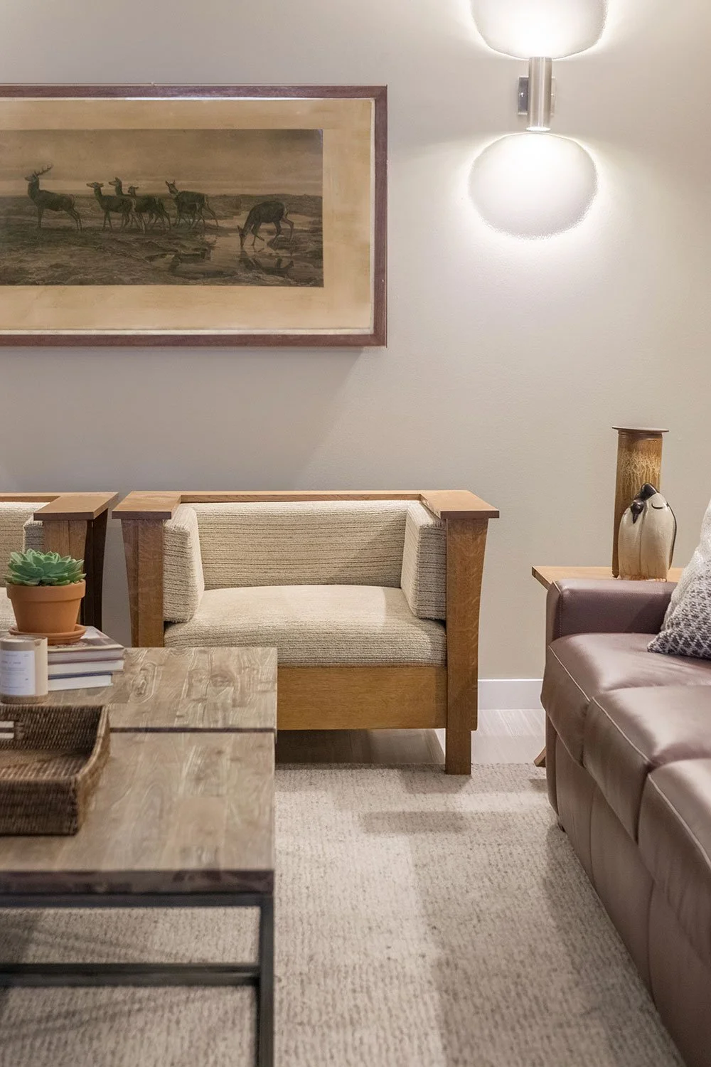 Den with handmade craftsman accent chairs and a brown leather sleeper sofa.