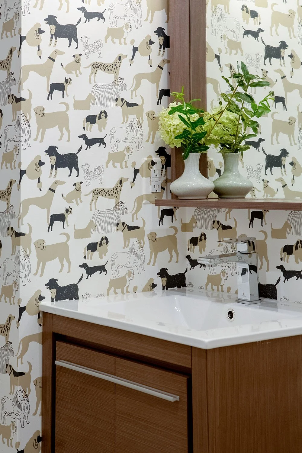 Powder rooom with wood vanity and dog illustration wallpaper.