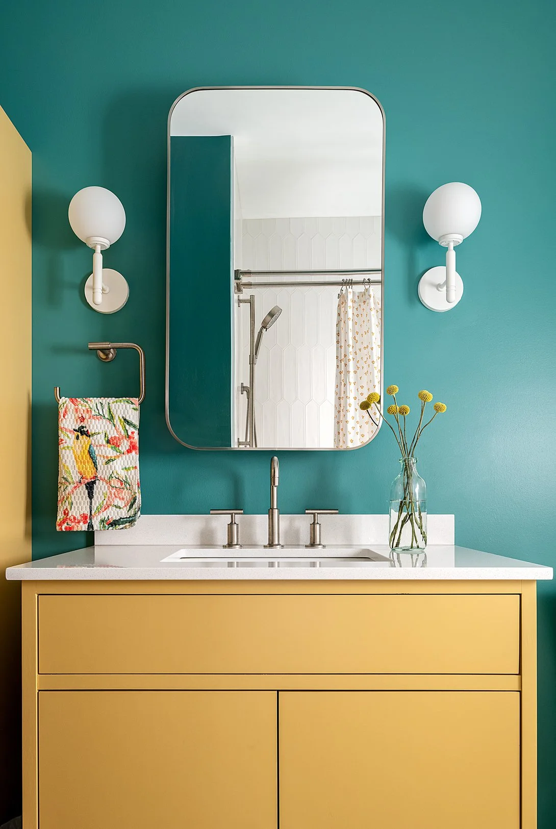 Full Bath with yellow vanity and teal walls.