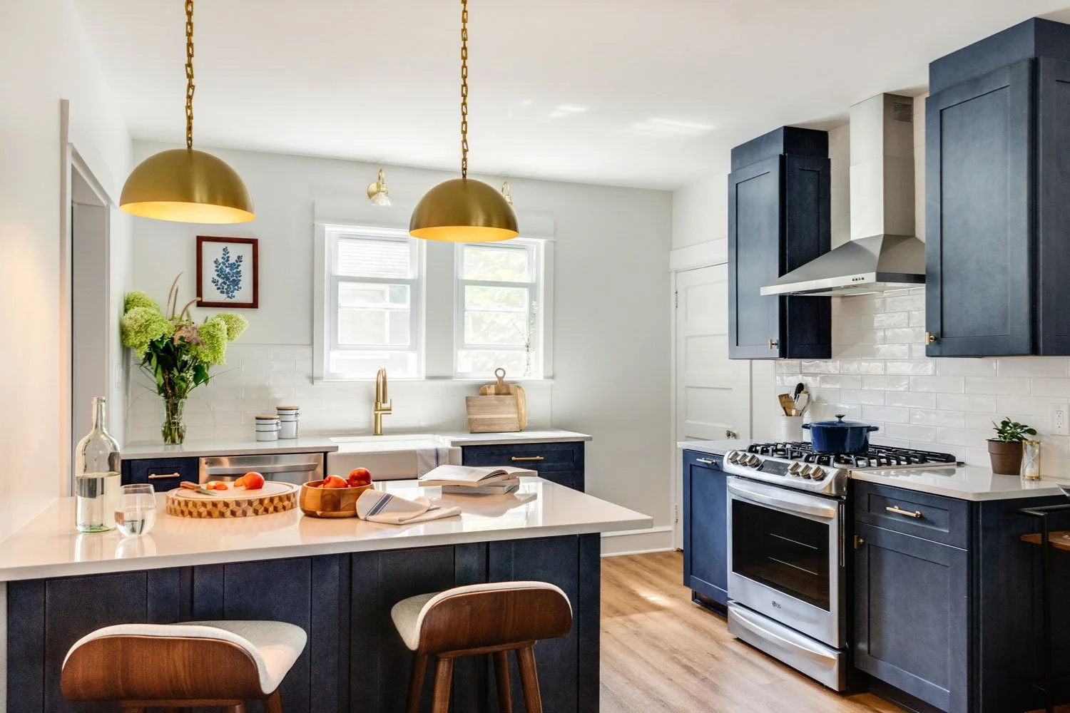 Kitchen with dark blue cabinetry and white subway tile.