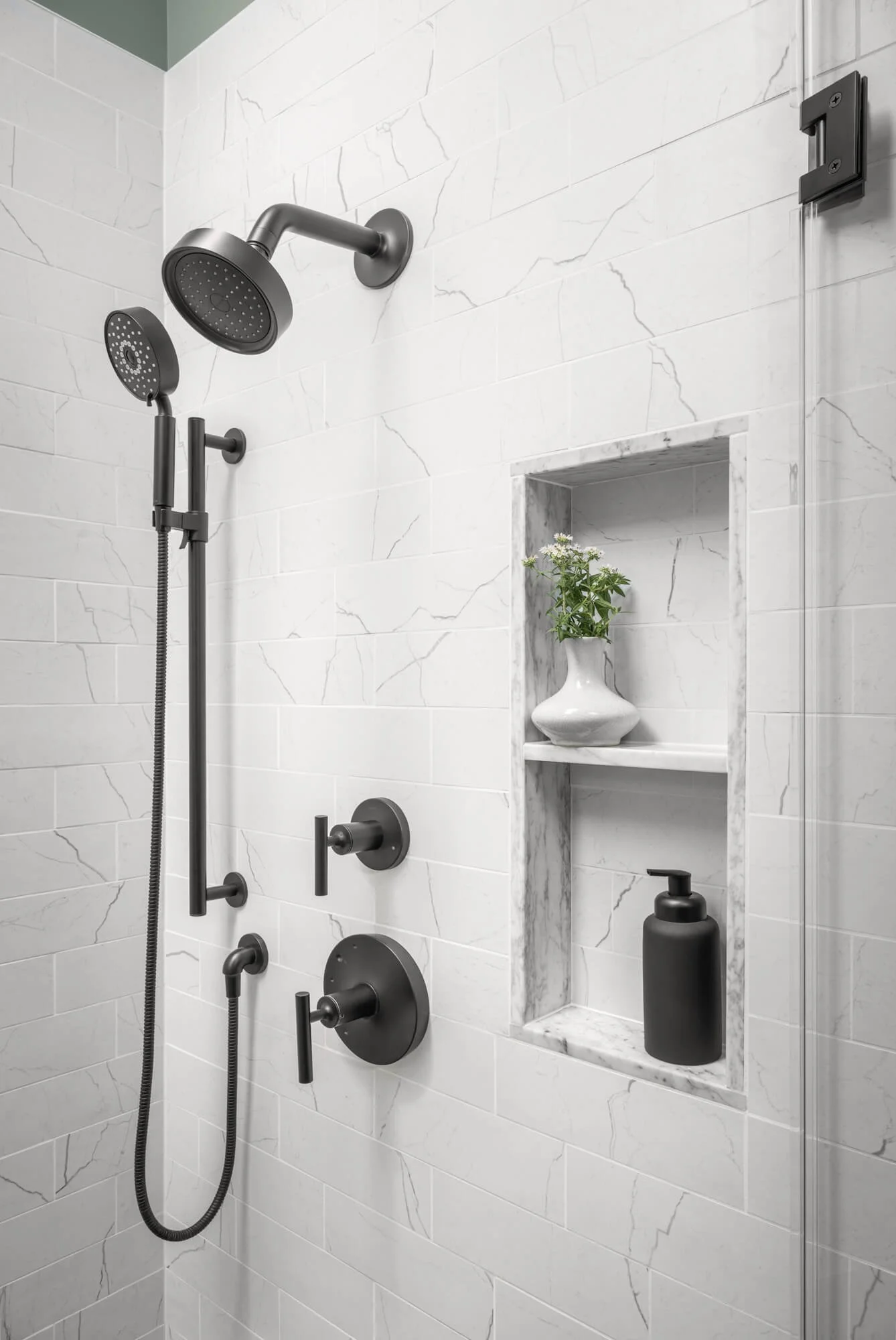 Marble-look shower with matte black fixtures.