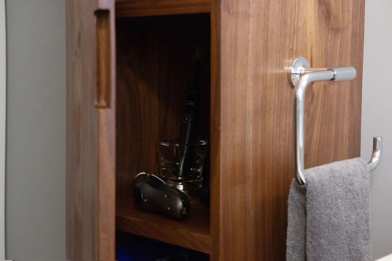 Custom walnut cabinet with electrical for charging a razor.