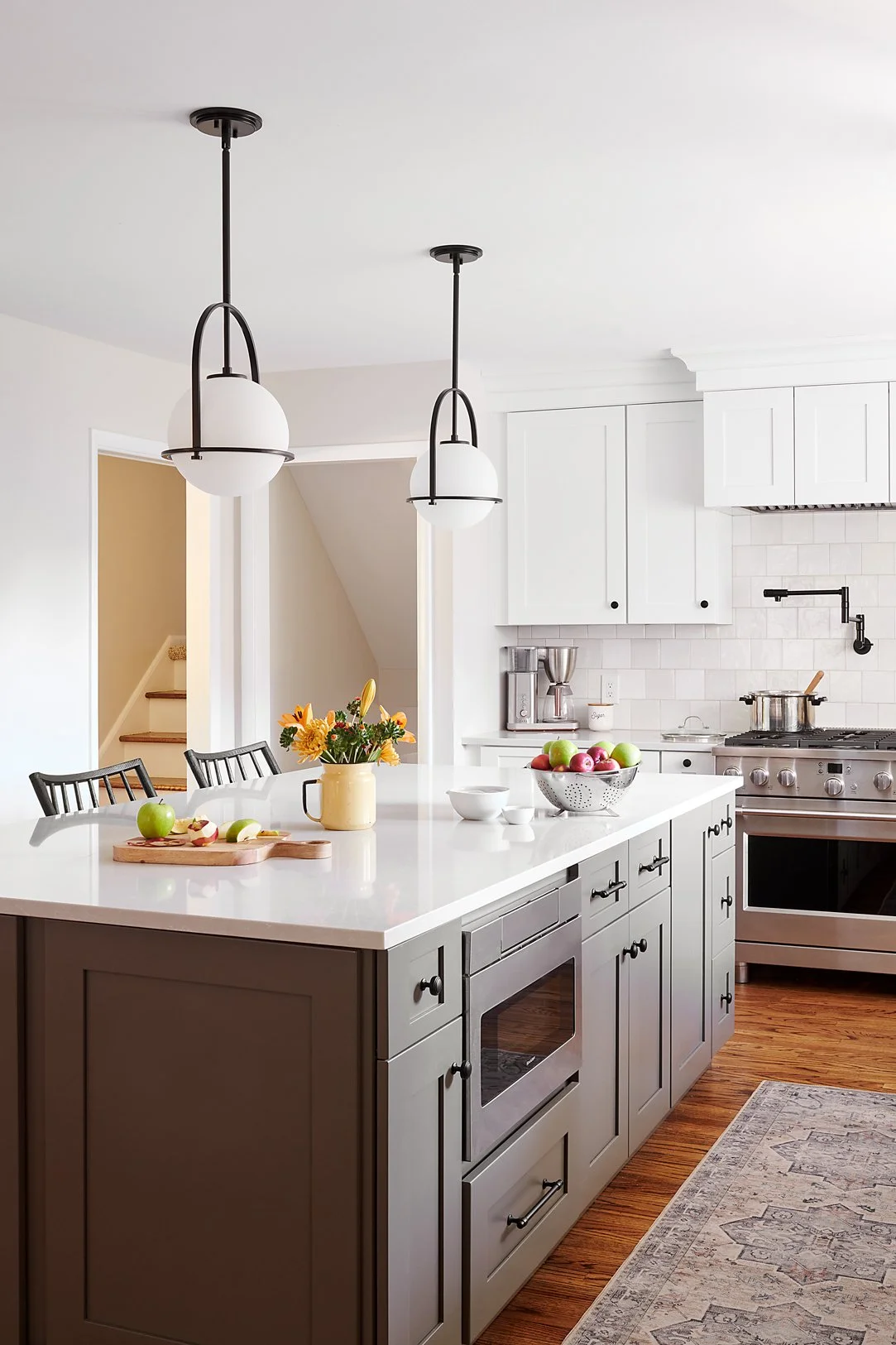 Dark kitchen island with under-counter microwave.