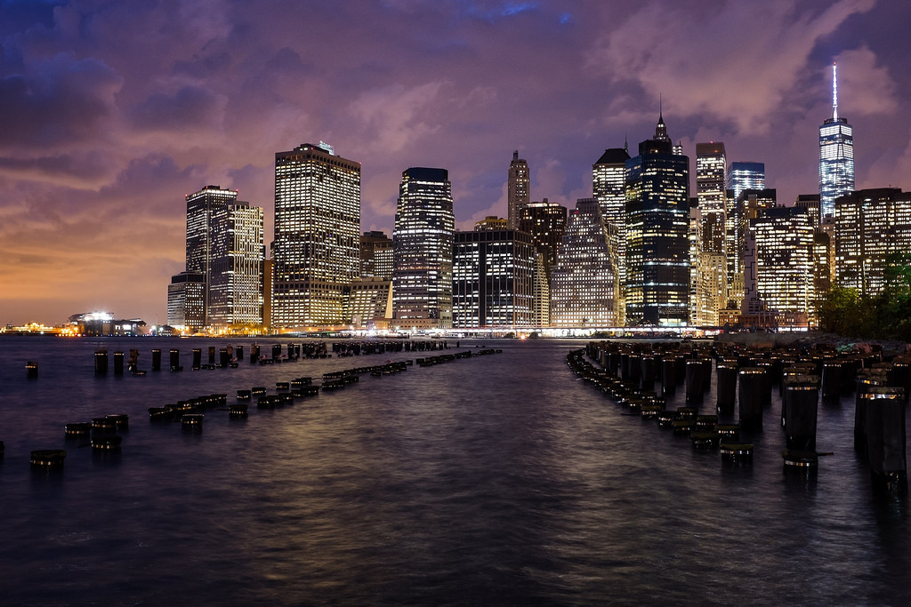 "Stormy Sunset in New York", October 2014, Brooklyn, New York Fujifilm X100s, 23mm, f/5.6, 2.6 sec, ISO 500 I've probably taken this shot of lower Manhattan from Brooklyn Bridge Park fifty times now. This one stands out for me, not just because of the amazing sky, but because of the way the metal bands on the tops of the pylons reflect the streetlights behind me. Usually, these poles either fall completely in shadow (like this ), or are partially lit and a bit distracting (like this ). But on this night, some alchemy of lights, angle and camera settings came together to give each silhouetted pylon a shimmering halo, mirroring the bands of lights along the skyline.