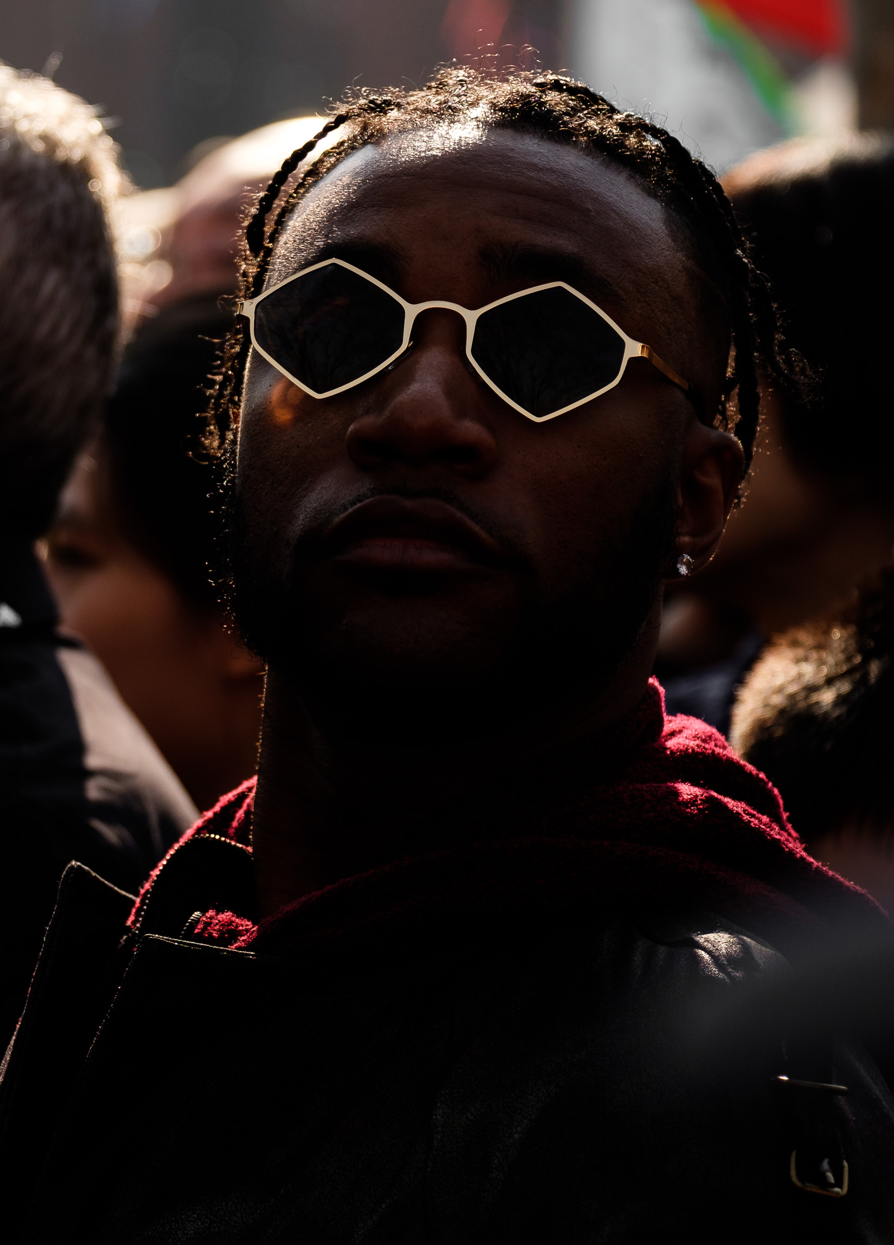 I underexposed this shot to dramatize the way the gold rims of this guy’s glasses caught the reflected sunlight.