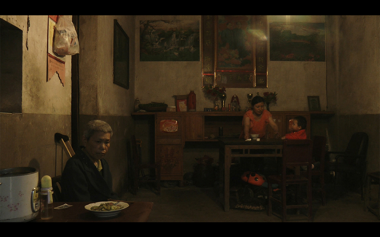 Another Year 2016 | China | Documentary | 181 min | HD | Color | Chinese Regional Dialect | TRAILER Director: Shengze Zhu | Producers: Zhengfan Yang & Shengze Zhu | Cinematographer: Zhengfan Yang | Sound Mix: Dejian Ou | English Subtitles Translation: Yiqian Zhang & Paola Iovene | Editing: Shengze Zhu Distributed by Torch Films (USA) in North America * Visions Du Réel International Film Festival (Switzerland, 2016) | Sesterce d’or - Best Film Award * RIDM - Montreal International Documentary Festival (Canada, 2016) | Grand Prize * Olhar de Cinema - Curitiba International Film Festival (Brazil, 2016) | Critics’ Award (Abraccine) * Millenium Film Festival (Belgium, 2017) | Special Jury Award * Astra Film Festival (Romania, 2017) | Honorable Mention * Art of the Real Festival, Film Society of Lincoln Center (USA, 2017) * Jeonju International Film Festival (South Korea, 2017) * Yamagata International Documentary Film Festival (Japan, 2017) * T-Mobile New Horizon International Film Festival (Poland, 2017) * Guangzhou International Documentary Festival (China, 2017) * Frontera-Sur Film Festival (Chile, 2017) * Open City Documentary Film Festival (UK, 2016) * Lima Independiente International Film Festival (Peru, 2016) * Indie Festival (Brazil, 2016) * Vladivostok International Film Festival "Pacific Meridian" (Russia, 2016) * Message to Man International Documentary Festival (Russia, 2016) * forumdoc.bh (Brazil, 2016) * Human Rights Film Festival (Croatia, 2016) * Spoutnik Art House Cinema (Switzerland, 2016) * Filmpodium Zürich (Switzerland, 2017) SYNOPSIS: The film captures 13 dinners of a Chinese migrant worker’s family over the course of 14 months. Beginning and ending around the Chinese New Year, the meals unfold in realtime through single long takes, which, in turn, reveal the rhythm of a family’s life on the margins of Chinese urban society. Attention is paid to dramatic events in their life, such as the grandma's stroke, as well as to mundane details such as arguments over how much salt the father added to the broth. Incessant economic pressures are presented at the dinner table through rambling conversations, and are as tangible as the chopsticks and steam pork. The joys and frustrations of the family are depicted in fine and complex details, highlighting how the mundane could appear both mysterious and beautiful with the passage of time. This film also suggests seeing the family as a lens for a deeper view into China’s economic boom and massive urbanization.