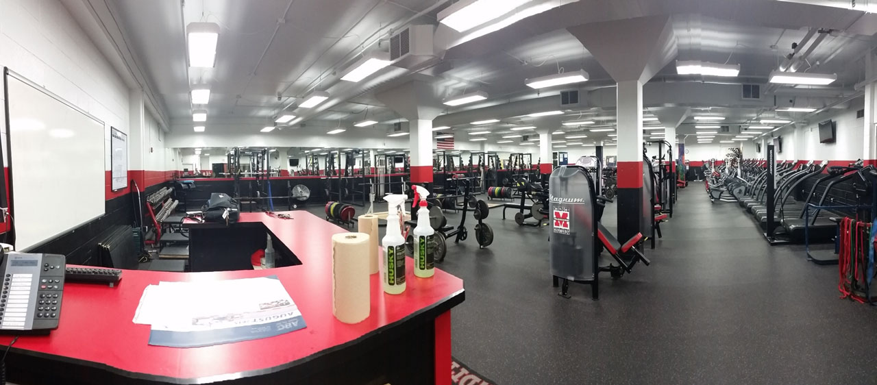 The new Muskego weight room is all about organization. Students pick up their program in the hall, slap the "Train Like a Champion" sign above the door, and check in at the front desk before training. The weight room also contains 4 video cameras to ensure athlete safety (and protect the strength coach from liability) at all times.