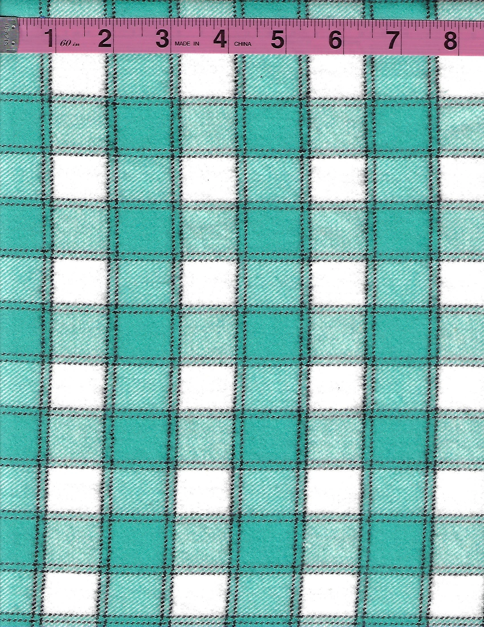 Marcus Fabrics Primo Plaid 100% cotton flannel fabric featuring a teal, turquoise, white, and black plaid pattern.