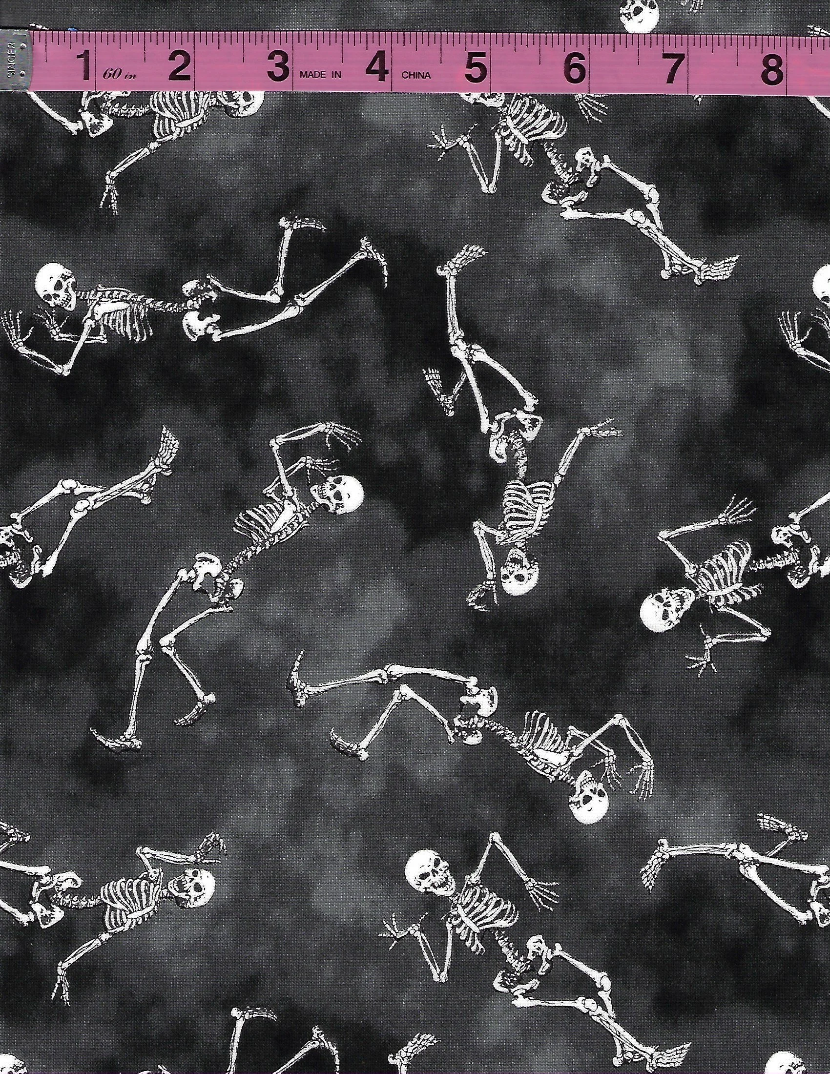Glow in the dark Halloween cotton fabric featuring skeletons and eyeballs on black backgrounds