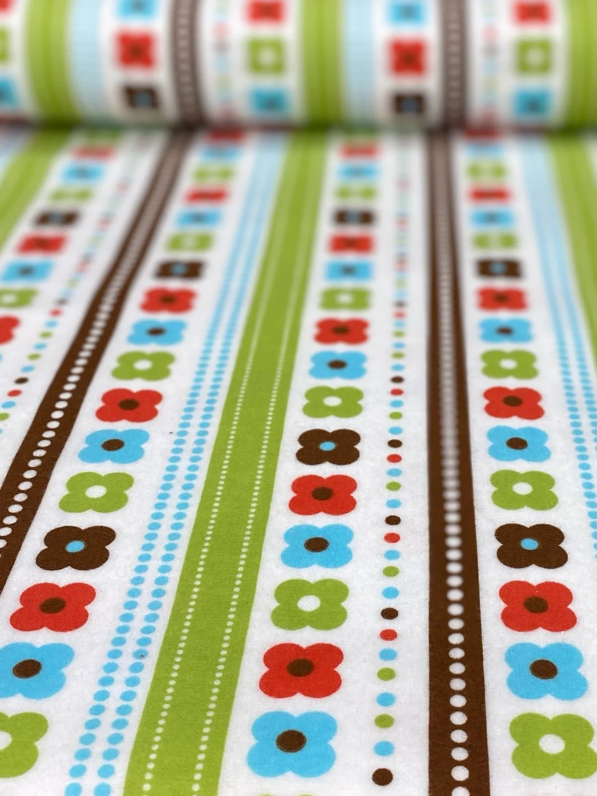 Cotton flannel fabric features flowers stripes and dots in a mod style by Robert Kaufman