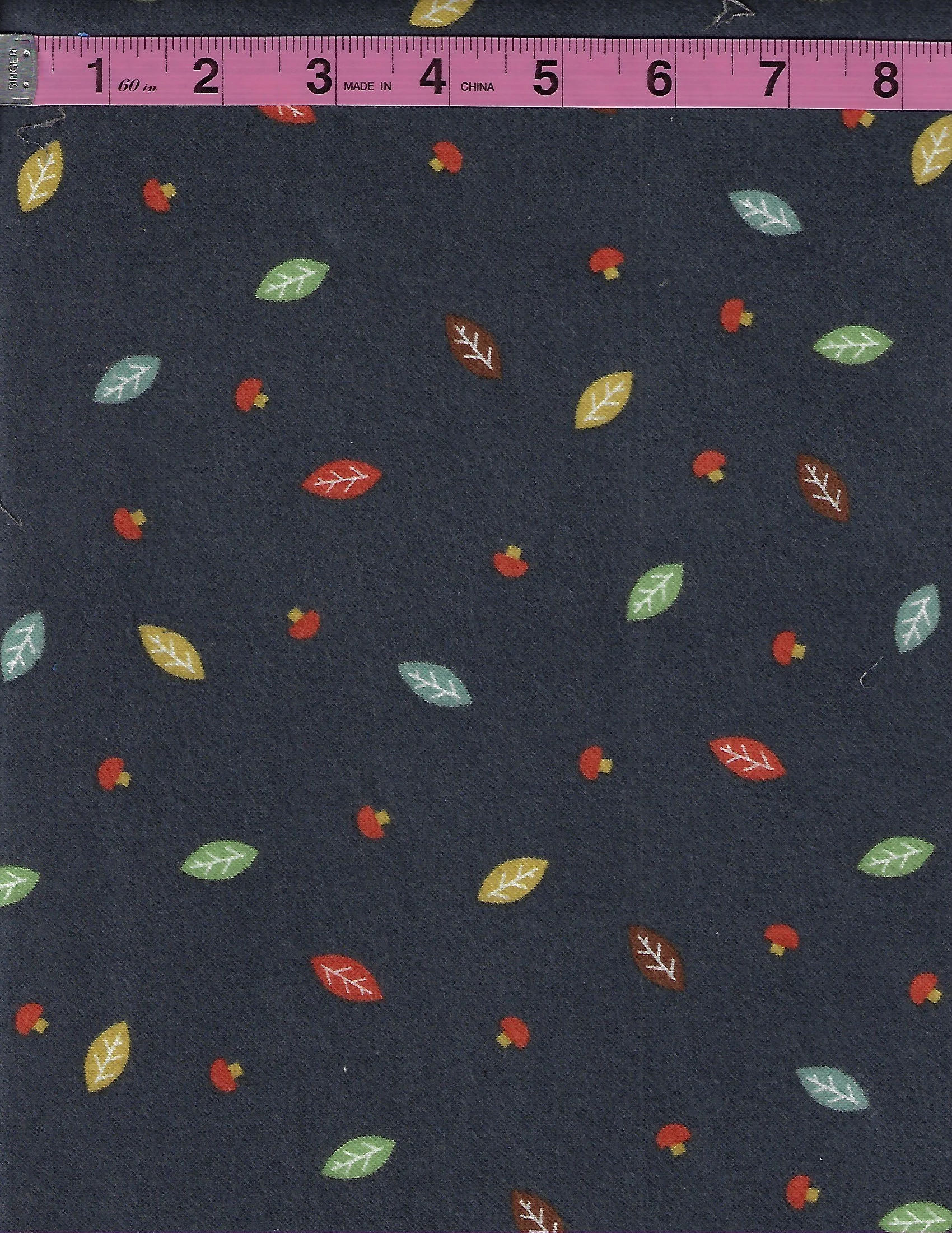 Riley Blake Designs cotton flannel fabric with colorful mushrooms and leaves on a dark navy blue background