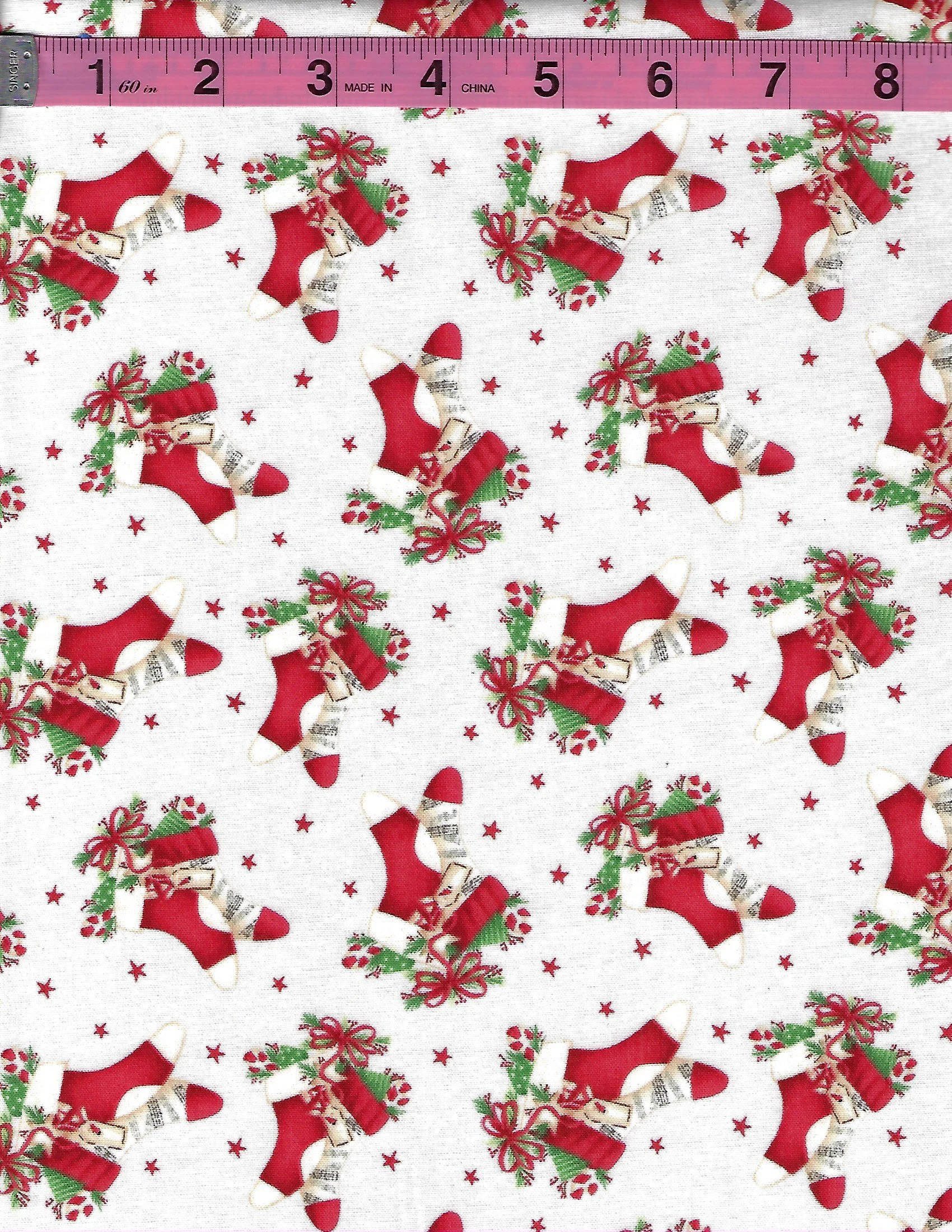 December Magic by Blank Quilting collection of four coordinating Christmas cotton fabrics featuring red and green ornaments, Christmas stockings, decorative holiday bells, and white and green snowflak
