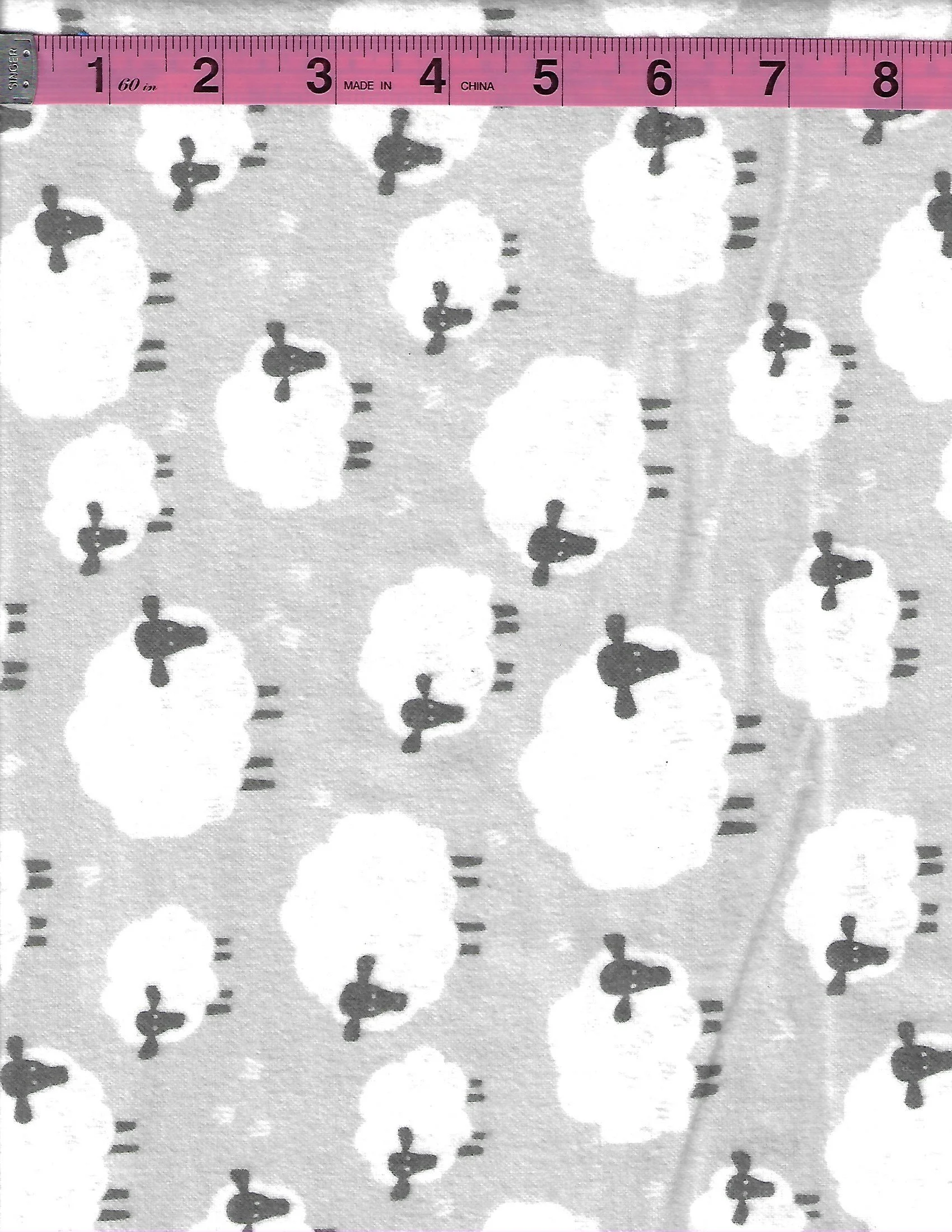 Riley Blake gray cotton flannel fabric with scattered white sheep and gray details