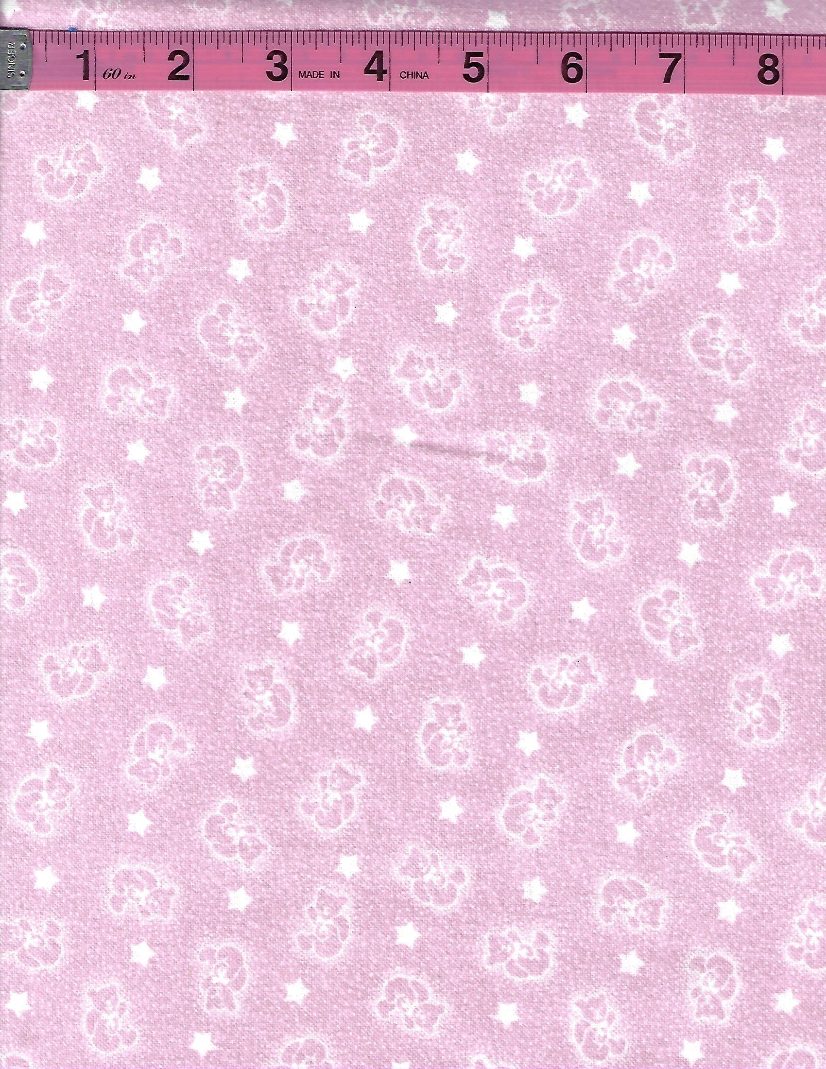 Soft pink flannel fabric featuring an adorable allover pattern of white teddy bears and scattered white stars