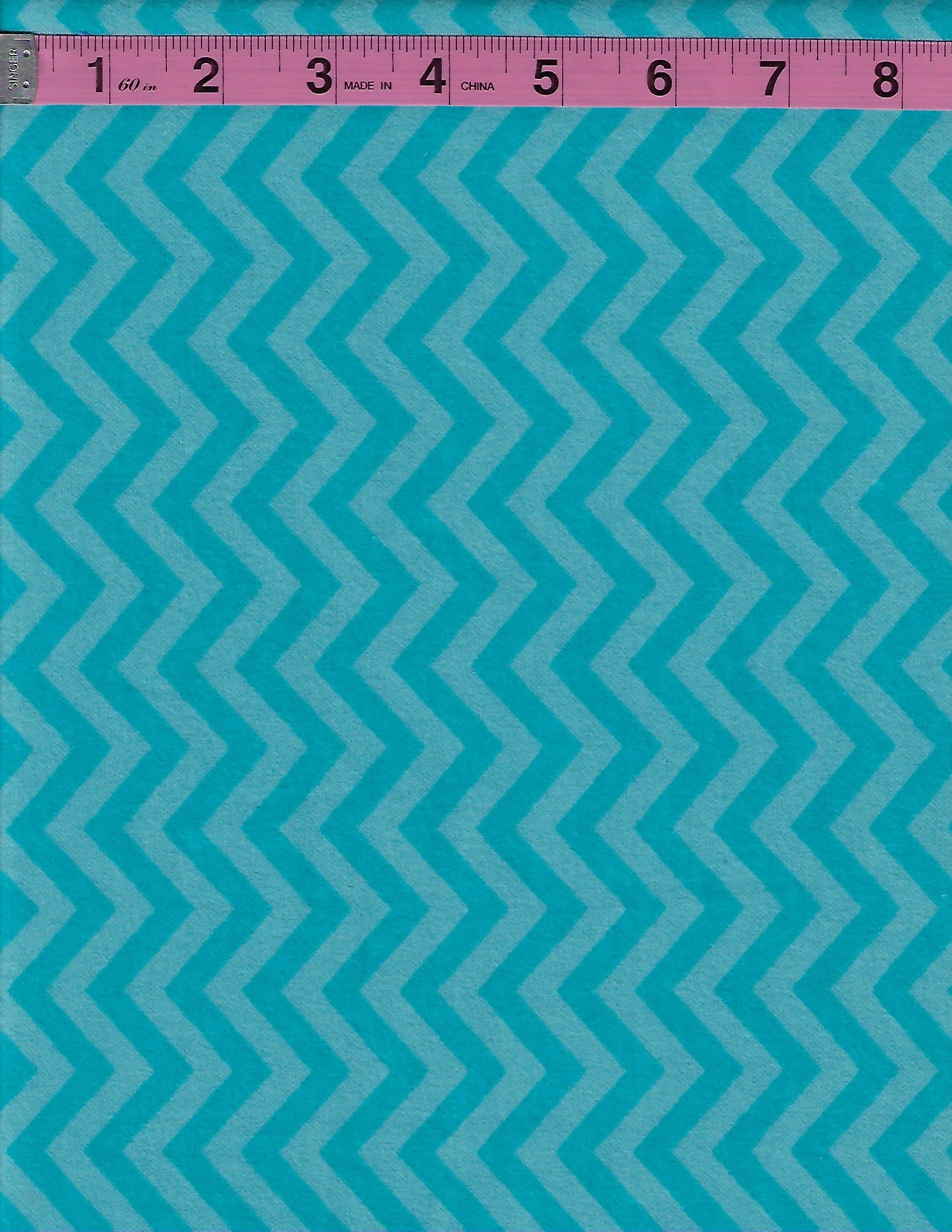 David Textiles 100% cotton flannel fabric featuring a repeating turquoise and light blue chevron zigzag pattern.