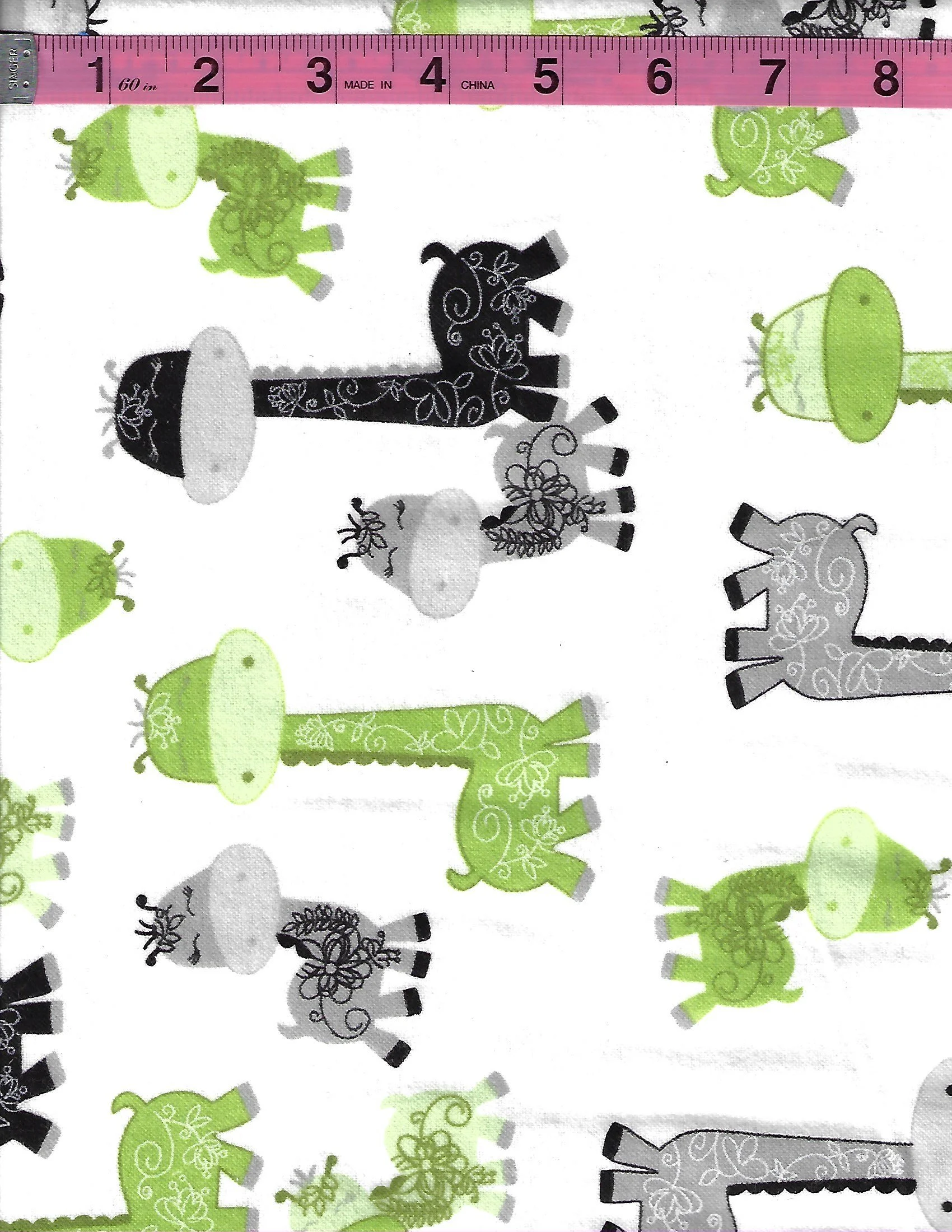 A.E. Nathan cotton flannel fabric with green, black and gray giraffes on a white background