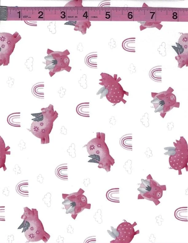 Studio E Porkopolis cotton fabric featuring cute pink pigs with rainbows and clouds on a white background