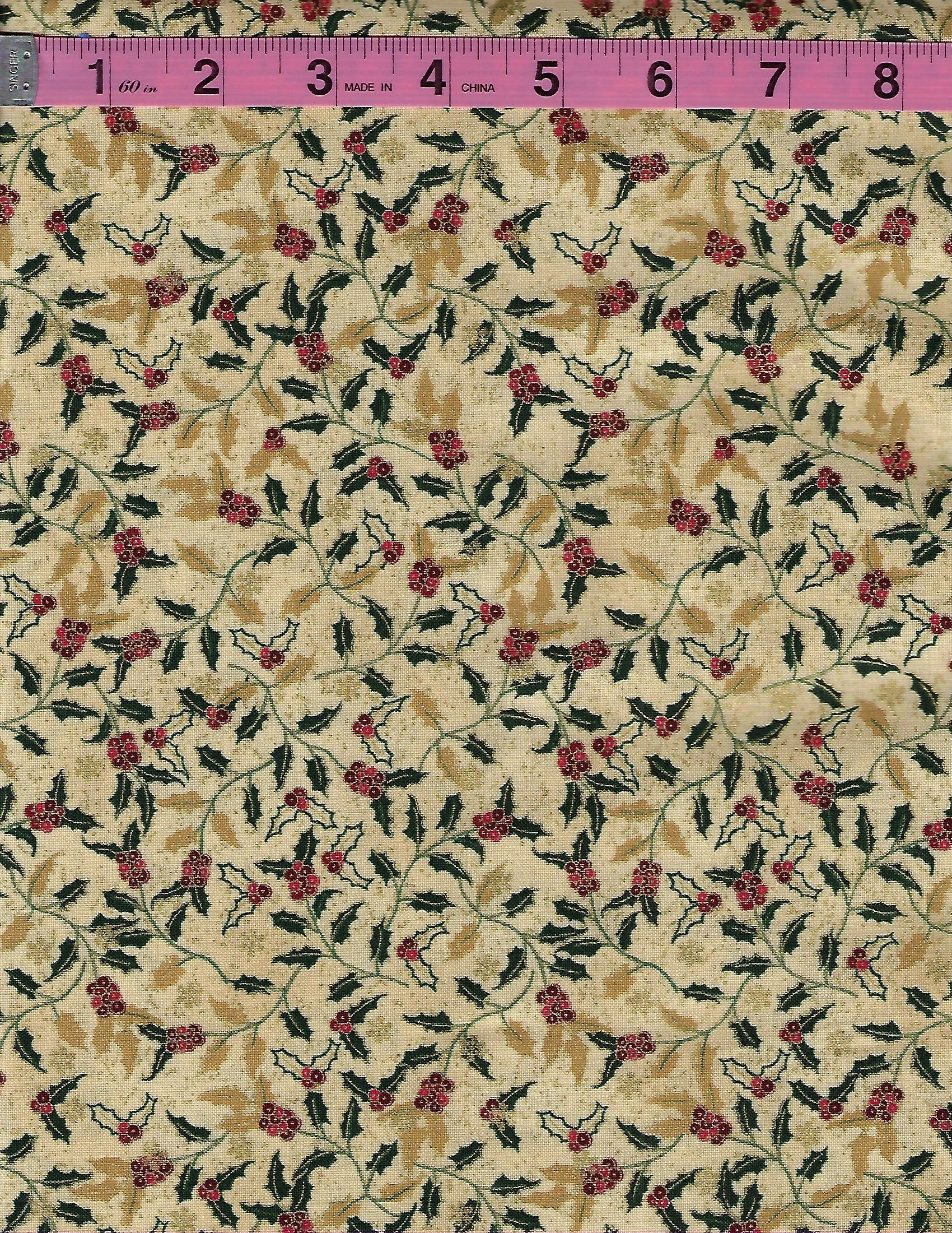 We Love Christmas by Blank Quilting coordinating cotton fabric pair featuring red holly berries and green leaves on a vintage cream background and gold swirling scrollwork on deep green fabric.