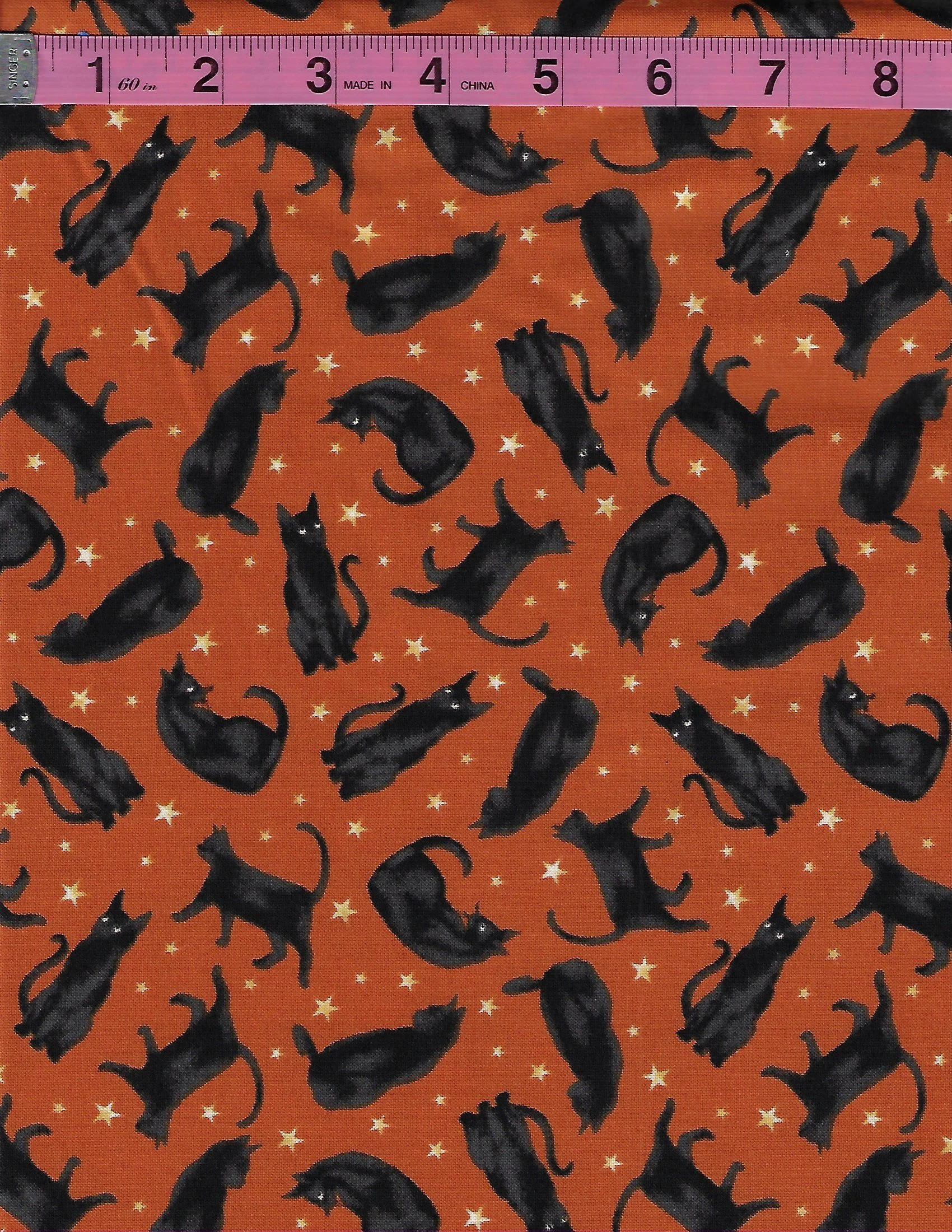 Studio E Harvest Moon 100% cotton fabric with black cat Halloween print on orange background and white stars