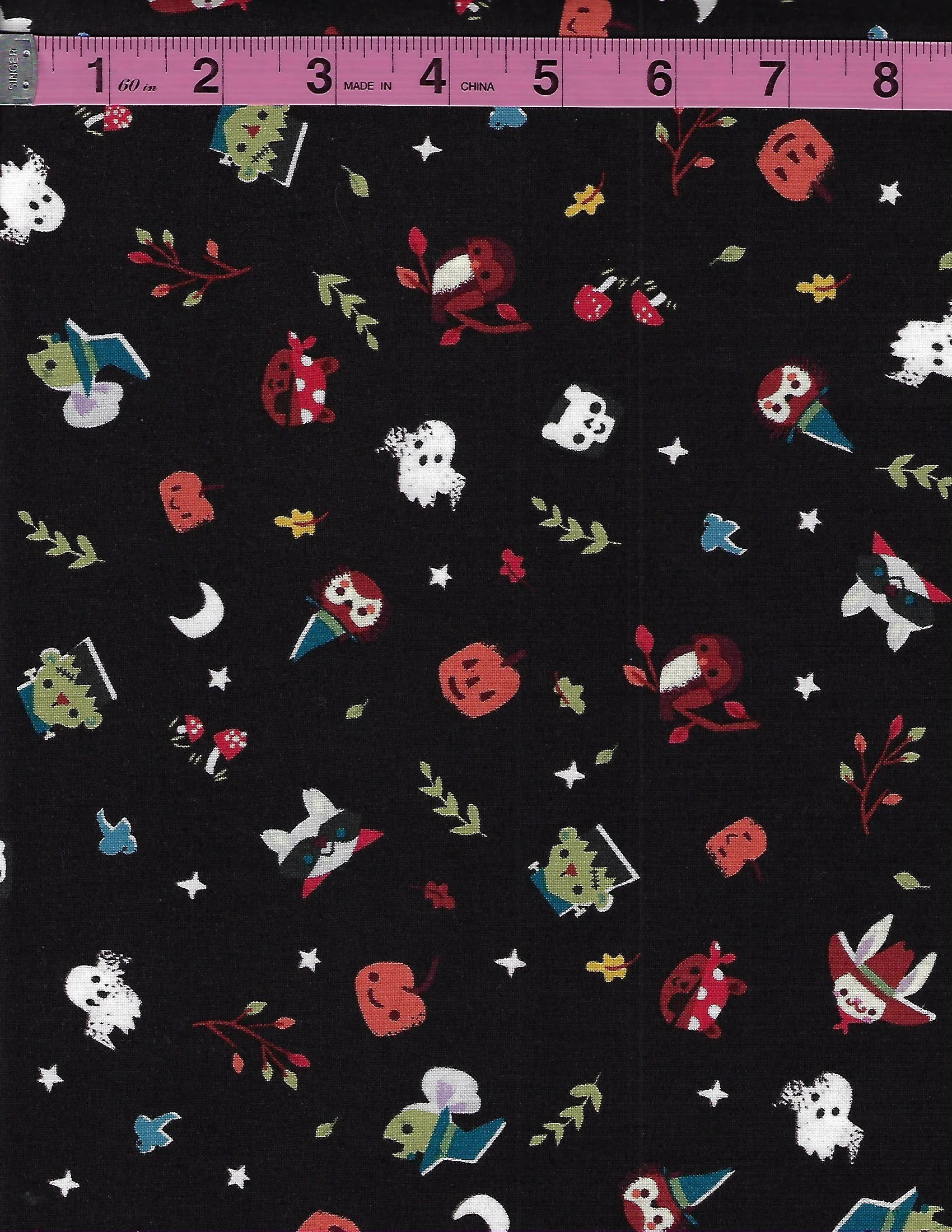 Riley Blake Designs Tiny Treaters glow-in-the-dark Halloween fabric featuring whimsical spooky characters and celestial night-sky motifs on black.