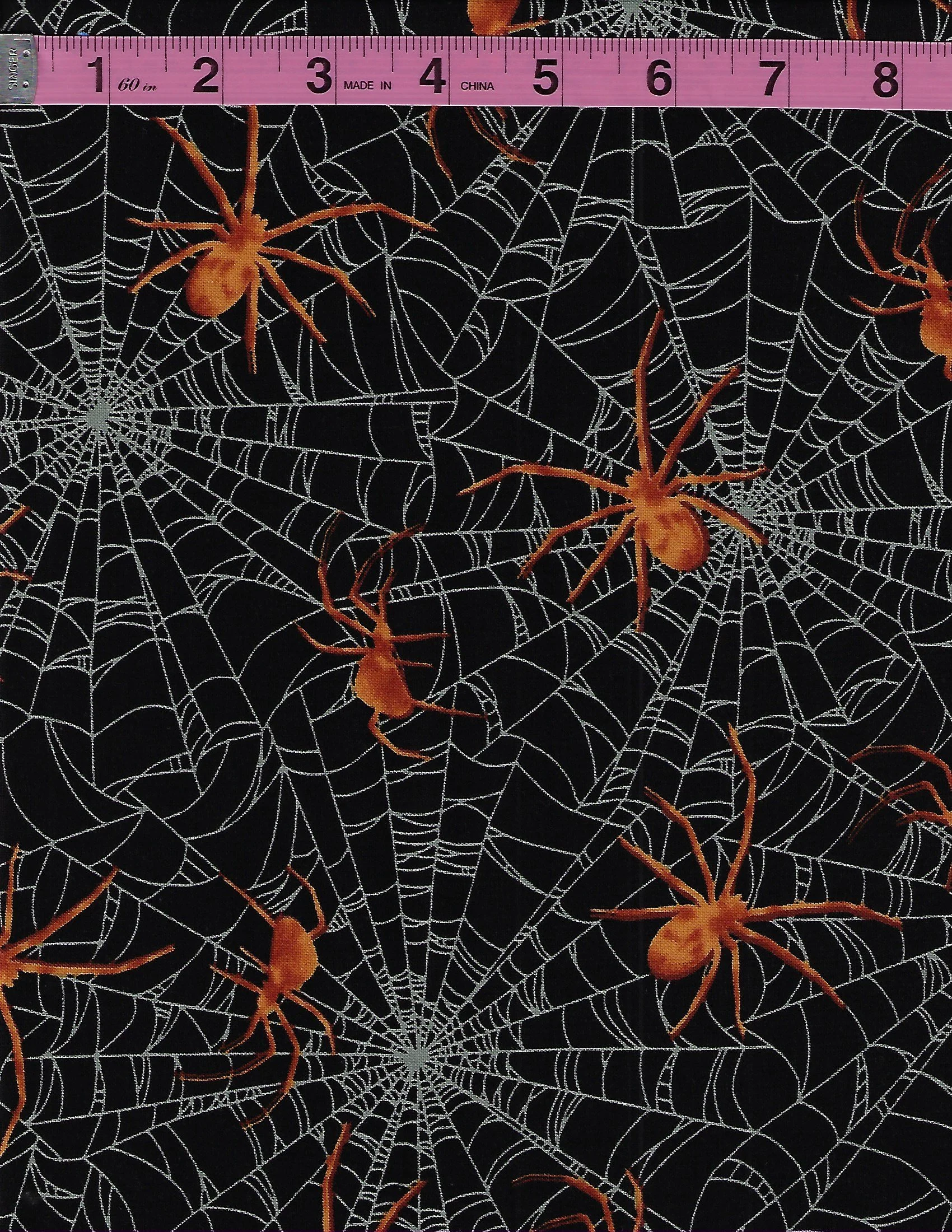 Studio E Harvest Moon black cotton fabric with white spider webs and orange spiders, 5244 Col 99.