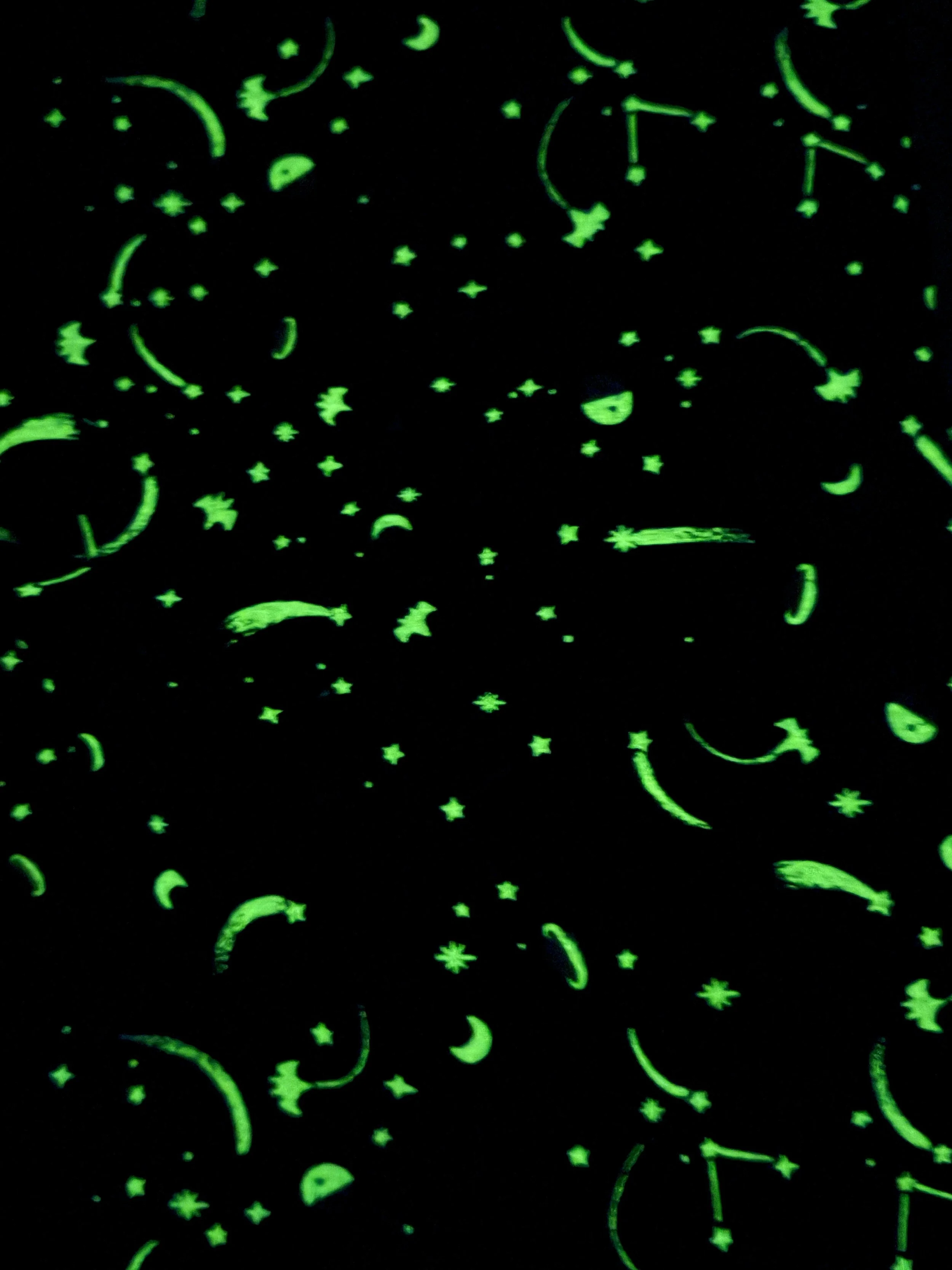 Riley Blake Designs Tiny Treaters glow-in-the-dark Halloween fabric featuring whimsical spooky characters and celestial night-sky motifs on black.
