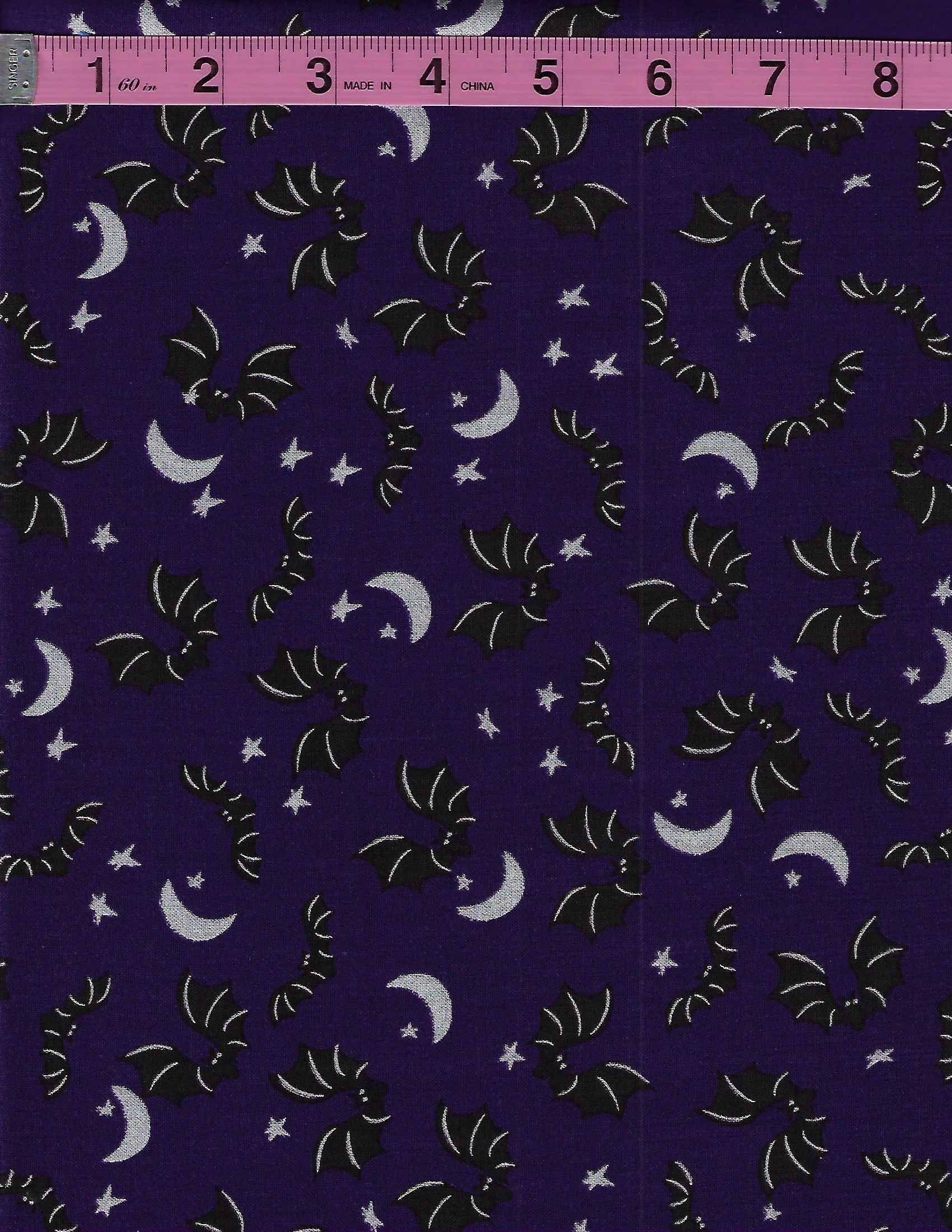 Riley Blake Spooky Hollow SC10572 fabric features black bats, crescent moons, and stars scattered across a rich eggplant purple background.