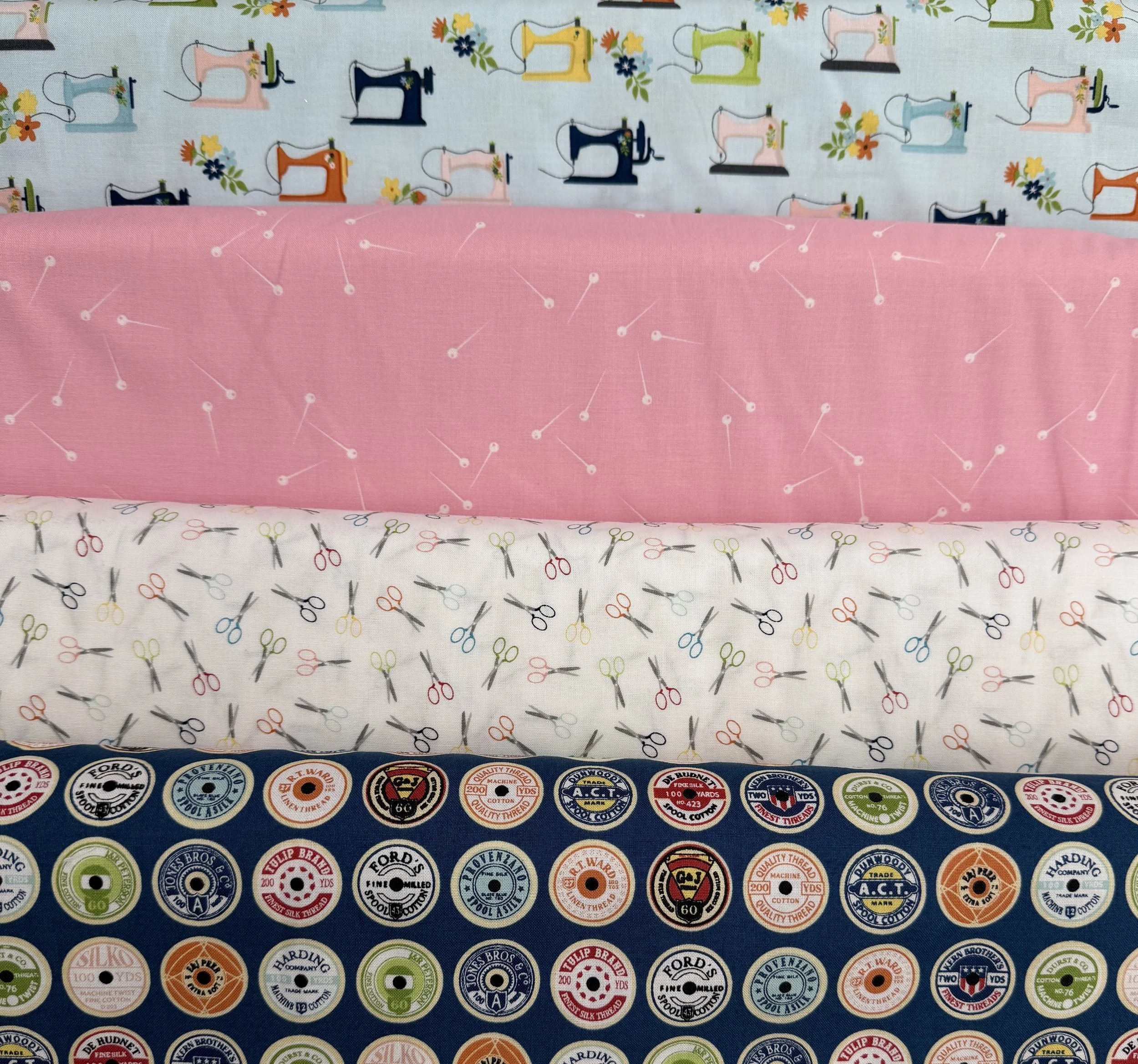 Riley Blake designs Vintage Sewing theme cotton fabric featuring spools of thread, scissors and vintage sewing machines