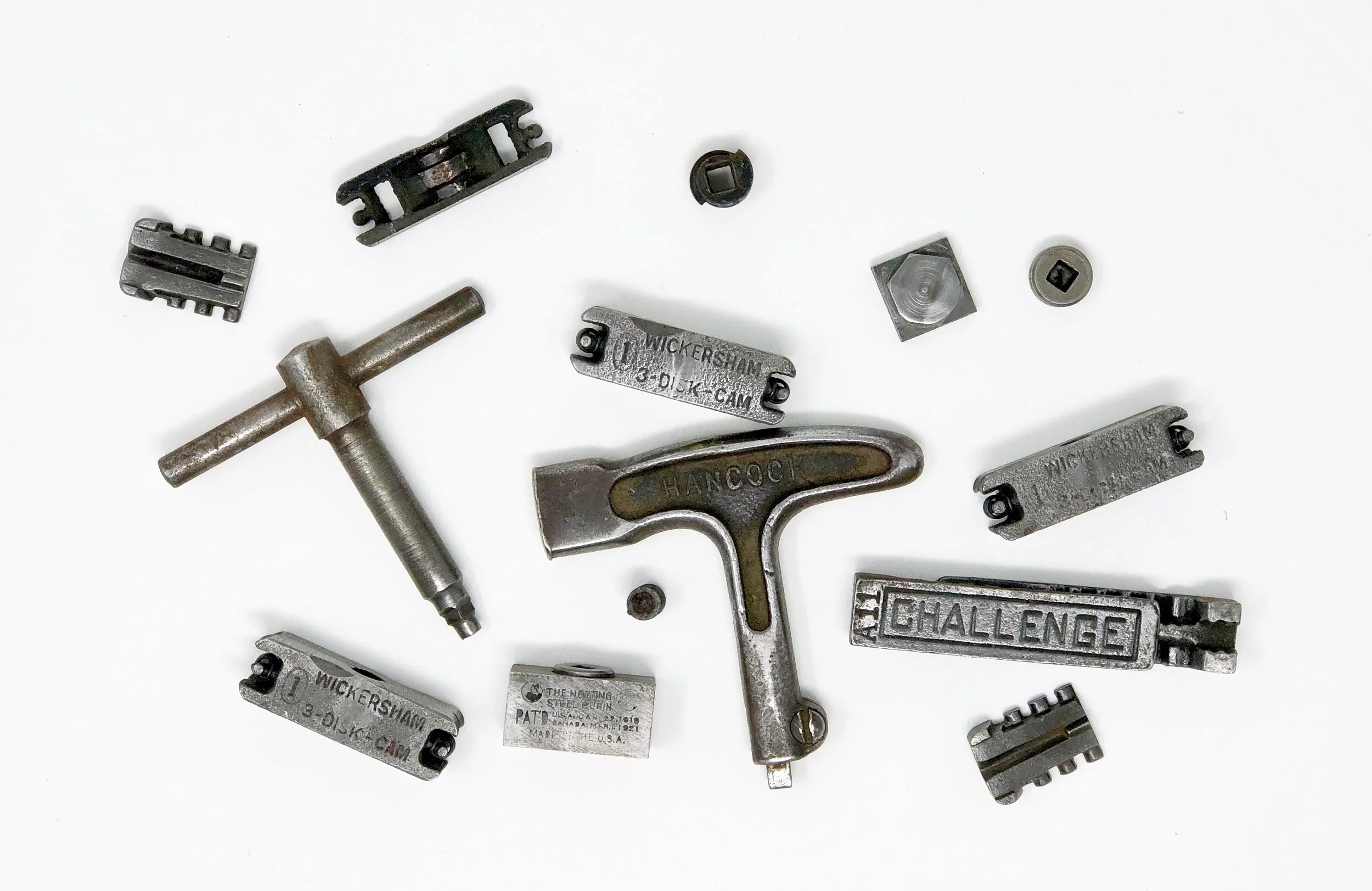 A variety of quoins, some of them disassembled, and two quoin keys.