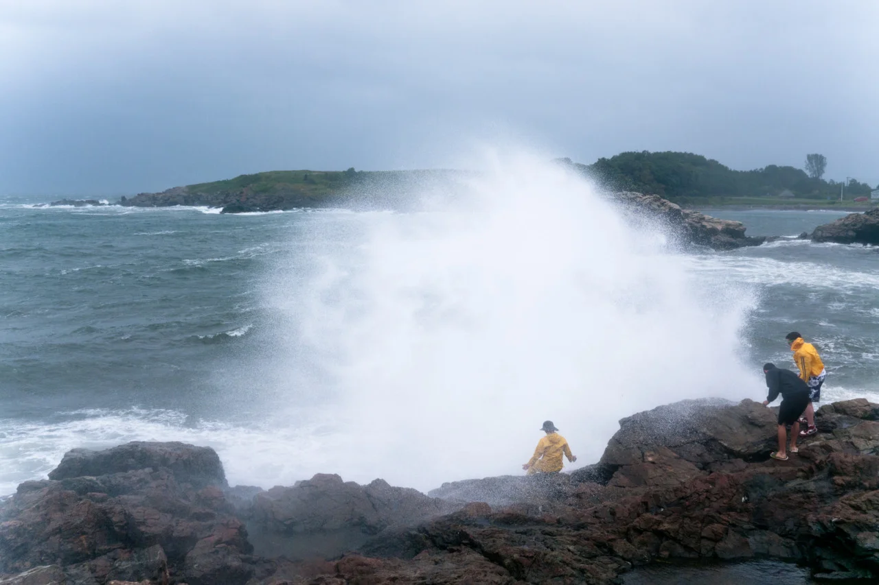 Piers gets engulfed by a wave from Hurricane Irene.