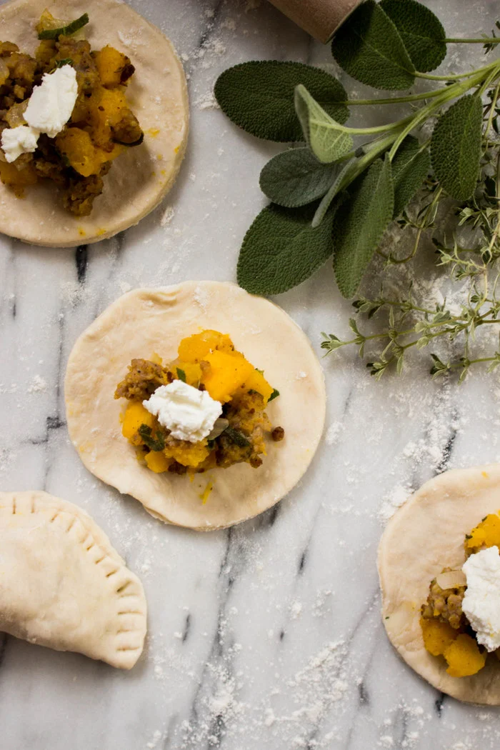 Squash, Sausage + Sage Empanadas with Goat Cheese