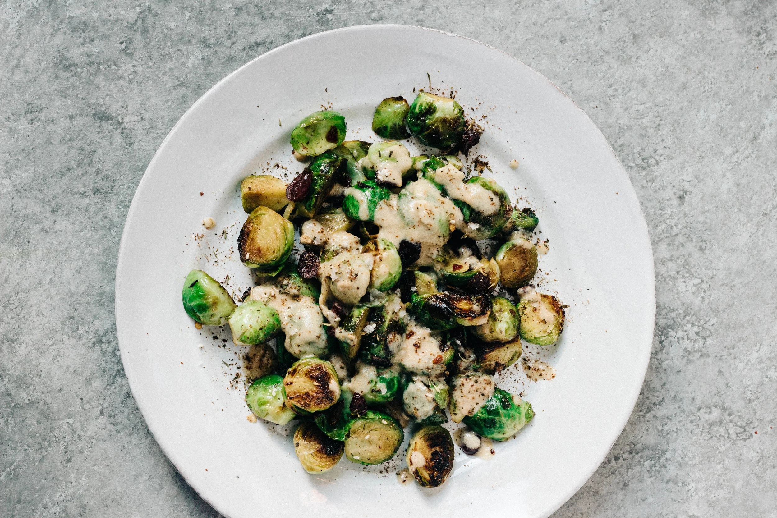 Roasted Brussels Sprouts with Cranberries, Tahini + Sumac