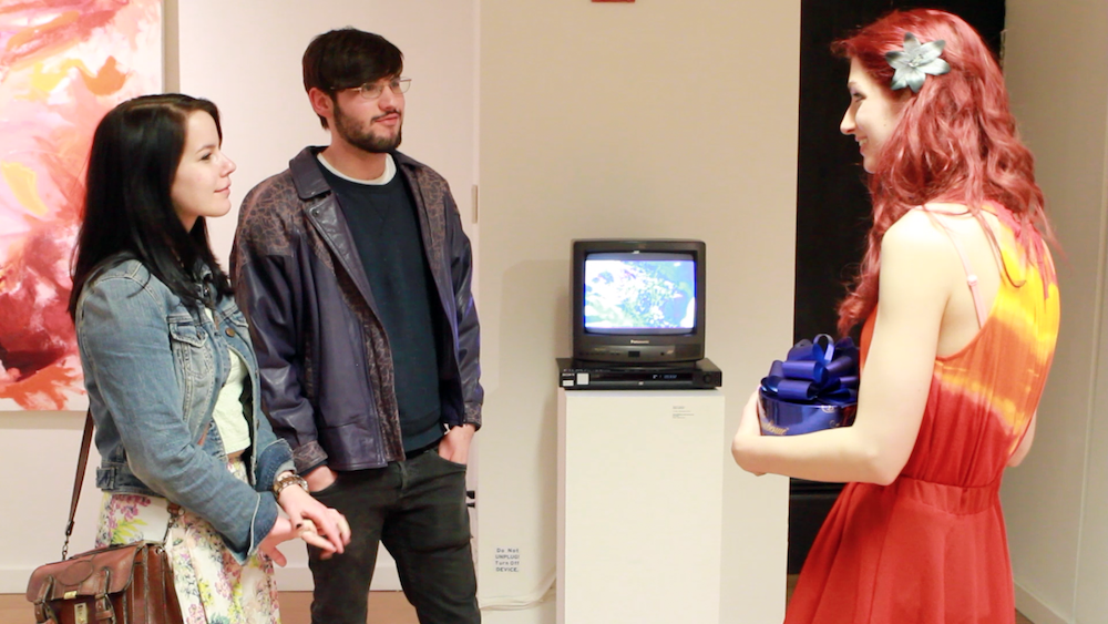 Devon Fisher speaks with Geena Matuson (@geenamatuson) at her TransFIREmation Gallery Show & Installation in the MassArt Student Life Gallery, 2013.