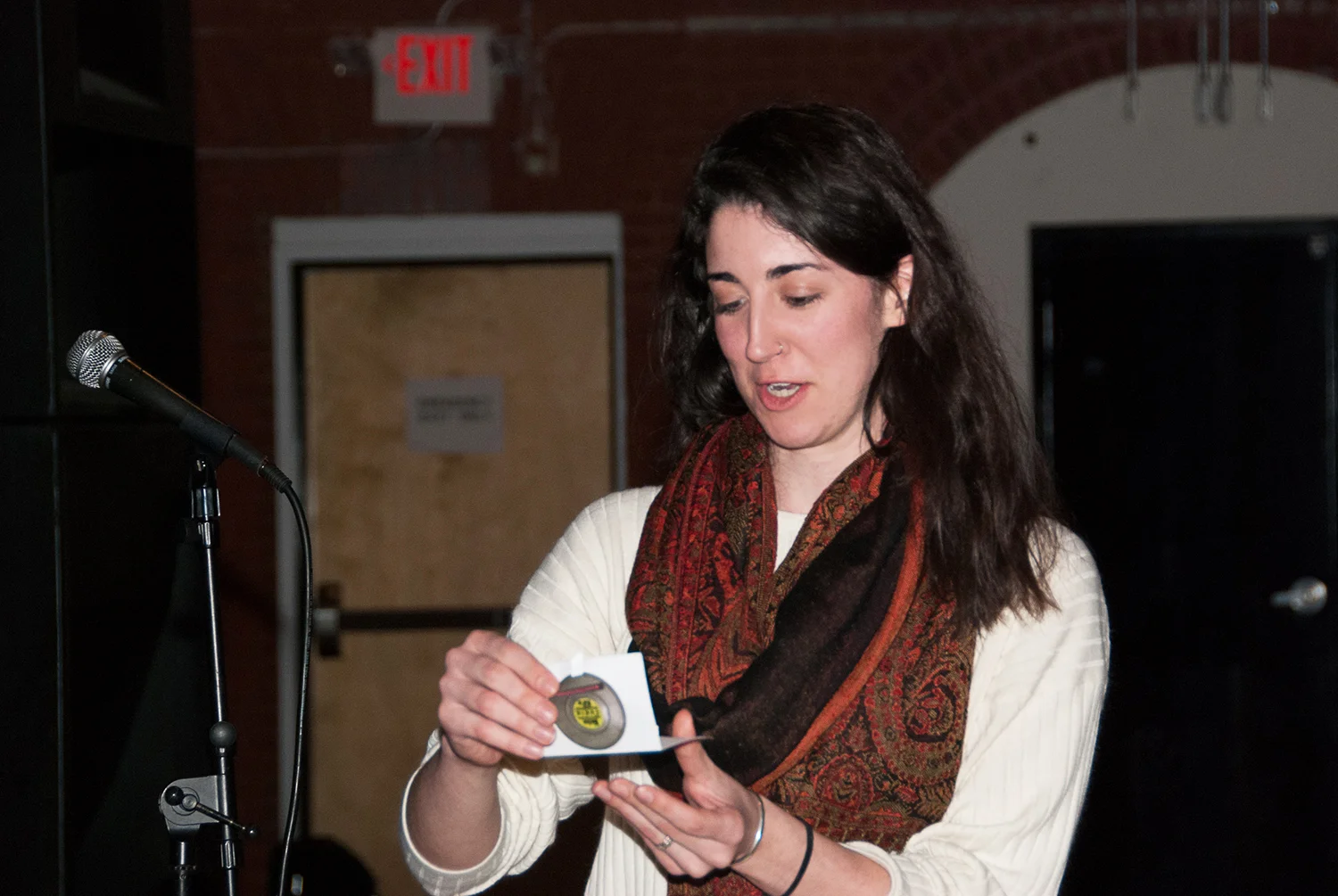 A 'Wicked Film Challenger' draws from a hat to determine the genre of her team's film at Boston Indie Mafia event, March 2015. Photo by Light Filters Studio.