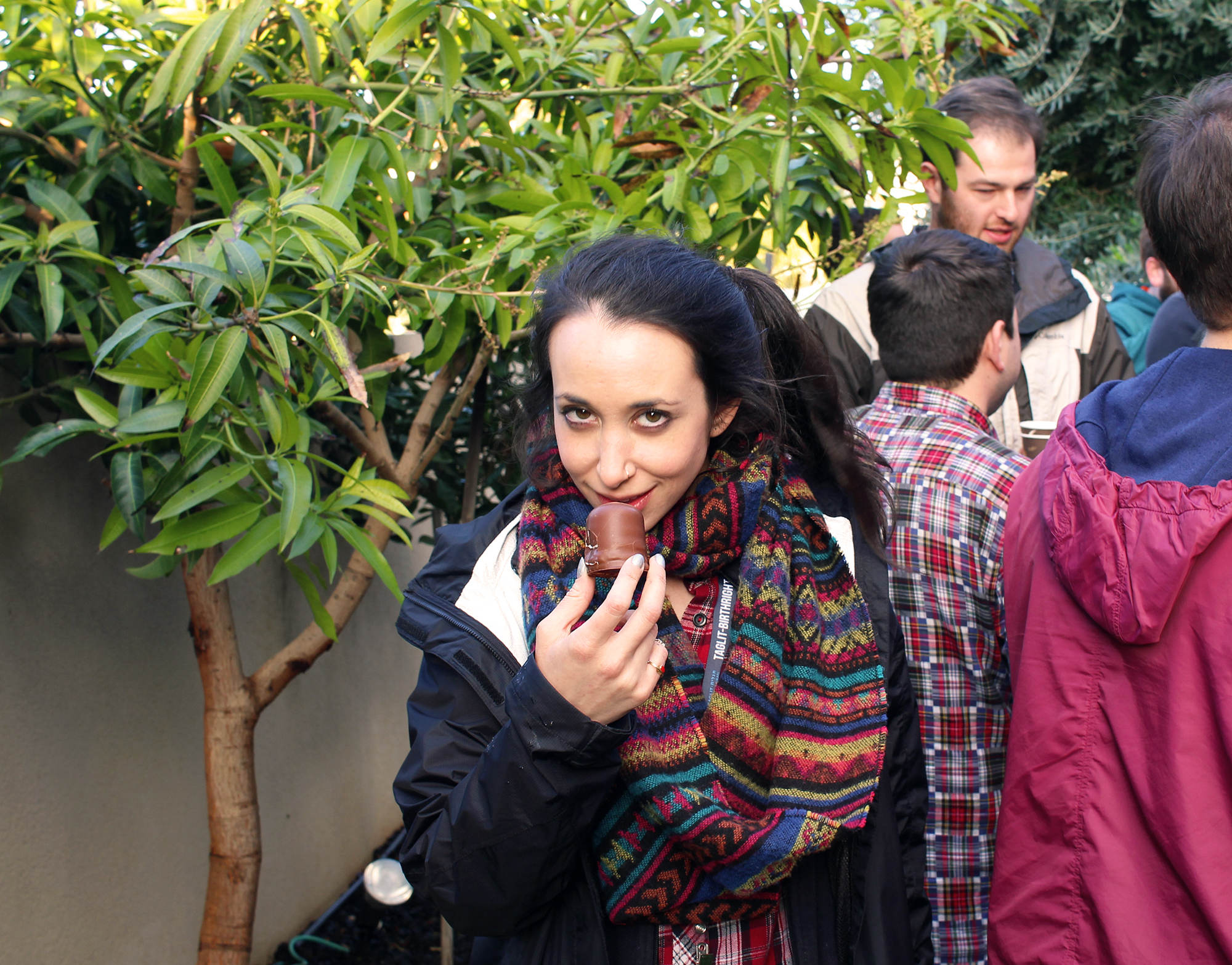 Group leader Rebecca Gold seductively plies a chocolate treat in the backyard of Nir's family home in Hadera, celebrating the second night of Hanukkah with Shorashim Israel, 2016.