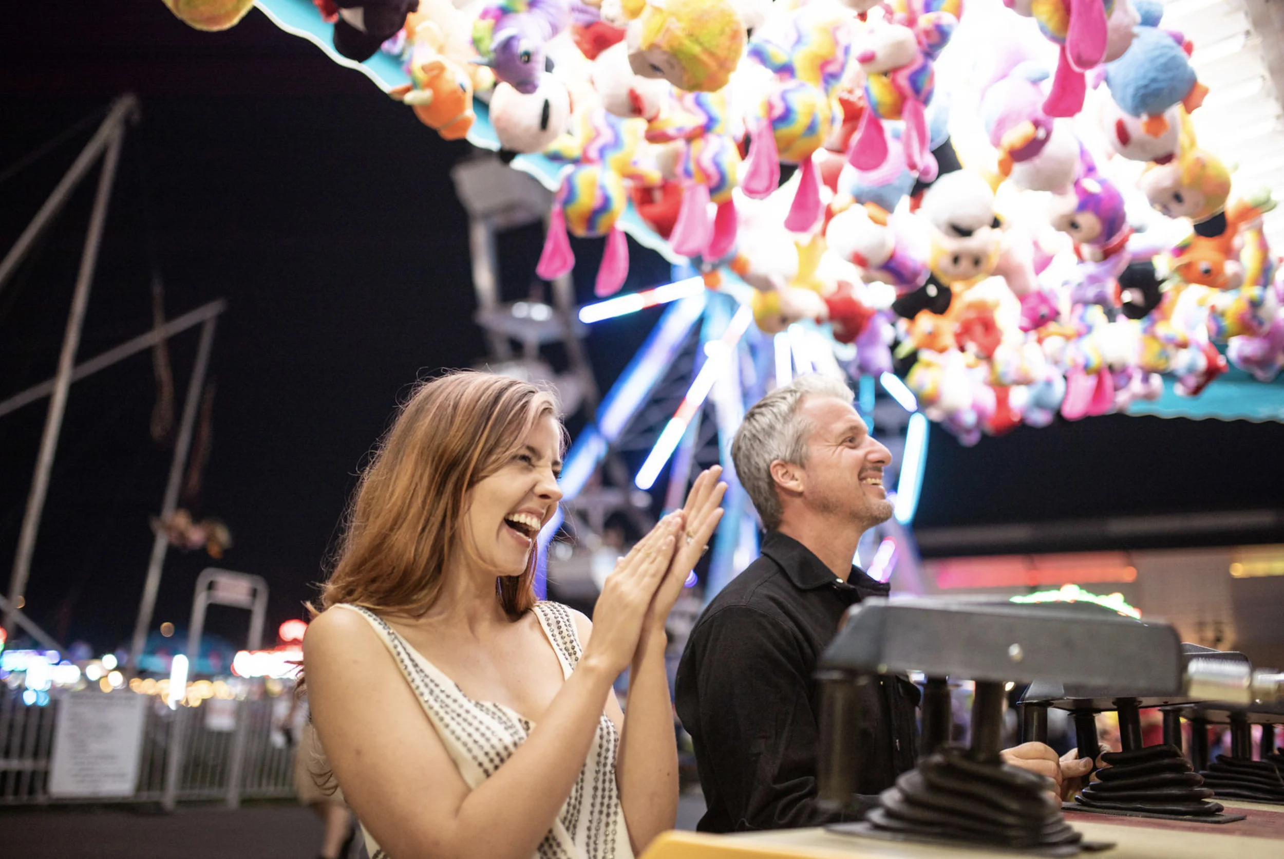 Zach Murphy of ZAM Photo (@zam.photo) shoot "A Night at the fair" with CD Geena Matuson (@geenamatuson) features neon lights in a carnival setting at the New York State Fair, with couple Jake Roberts and Molly Naef. See more @ zamphoto.net.