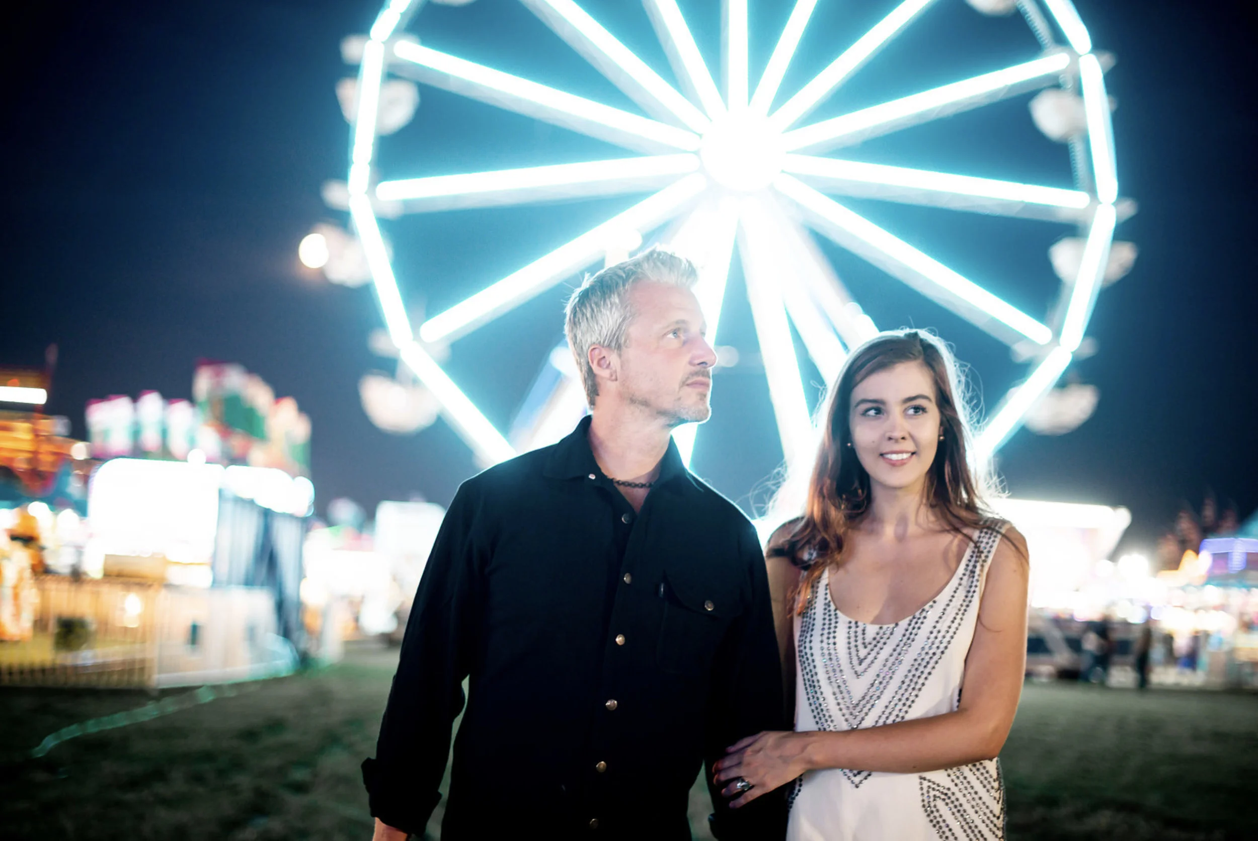 Zach Murphy of ZAM Photo (@zam.photo) shoot "A Night at the fair" with CD Geena Matuson (@geenamatuson) features neon lights in a carnival setting at the New York State Fair, with couple Jake Roberts and Molly Naef. See more @ zamphoto.net.