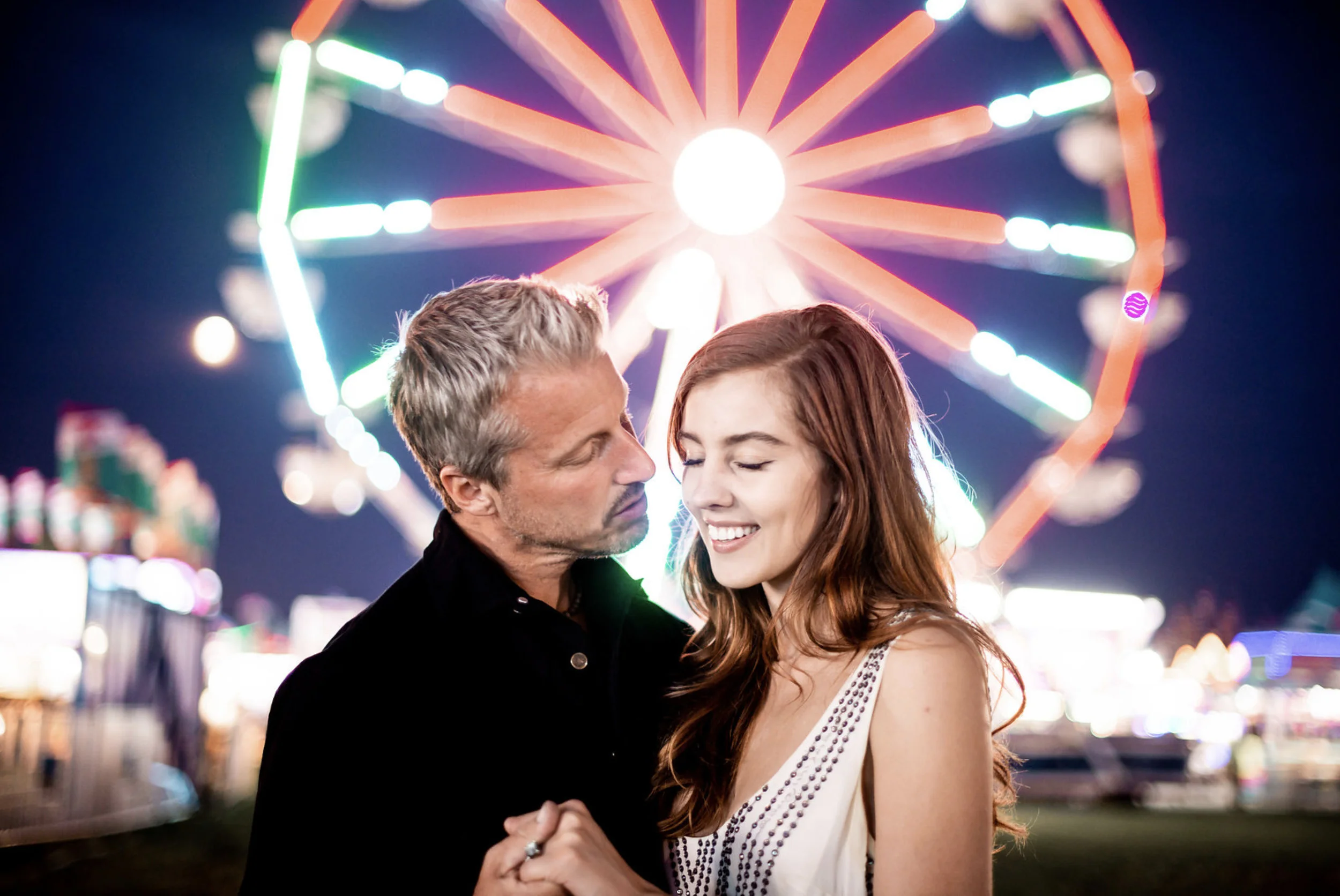 Zach Murphy of ZAM Photo (@zam.photo) shoot "A Night at the fair" with CD Geena Matuson (@geenamatuson) features neon lights in a carnival setting at the New York State Fair, with couple Jake Roberts and Molly Naef. See more @ zamphoto.net.