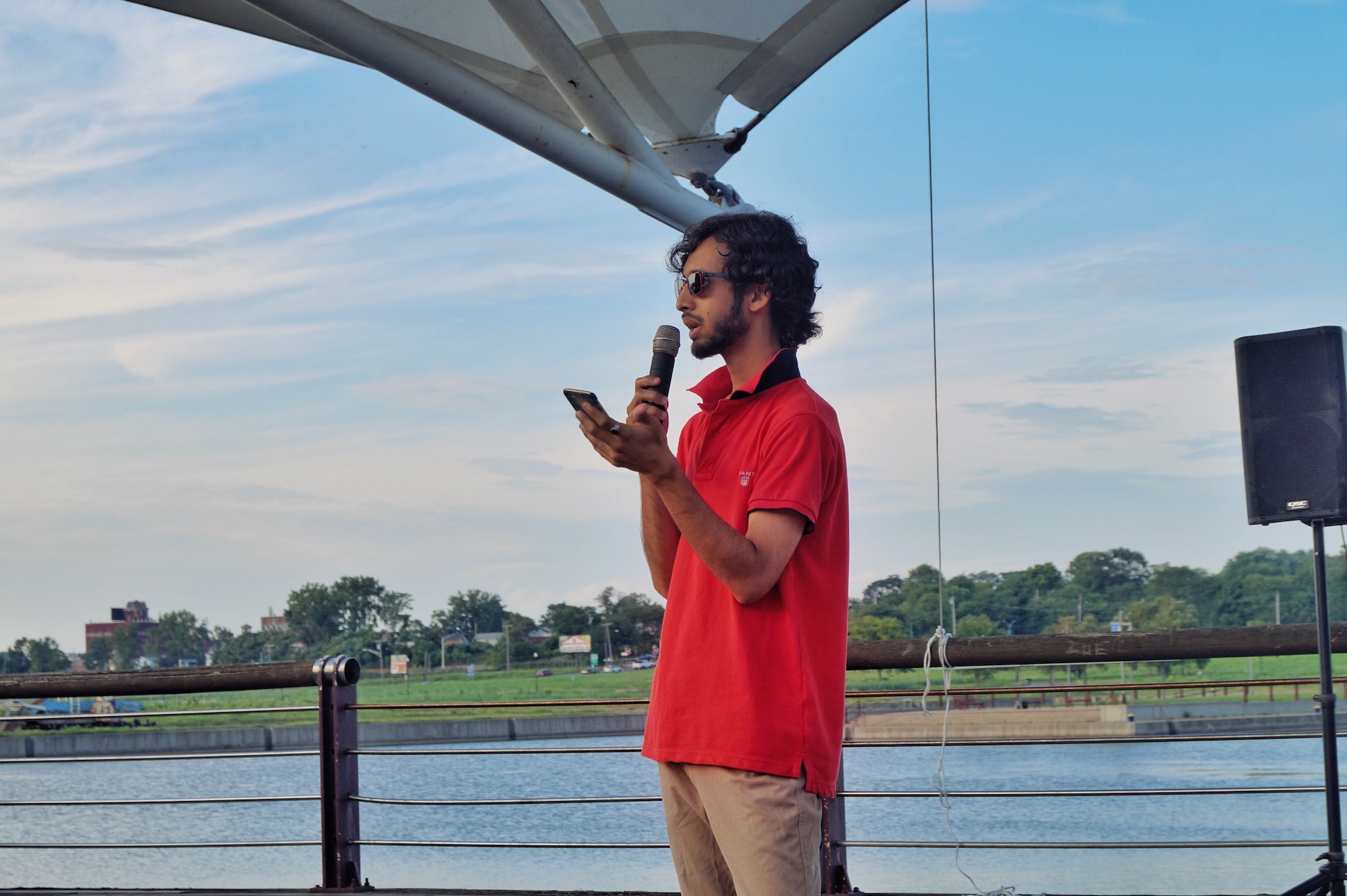 Lyle Michael reads poem at Mouri Pour Viv "Open Mic Day Party" in Syracuse, August 2018. Photography by Sajida Ayyup.