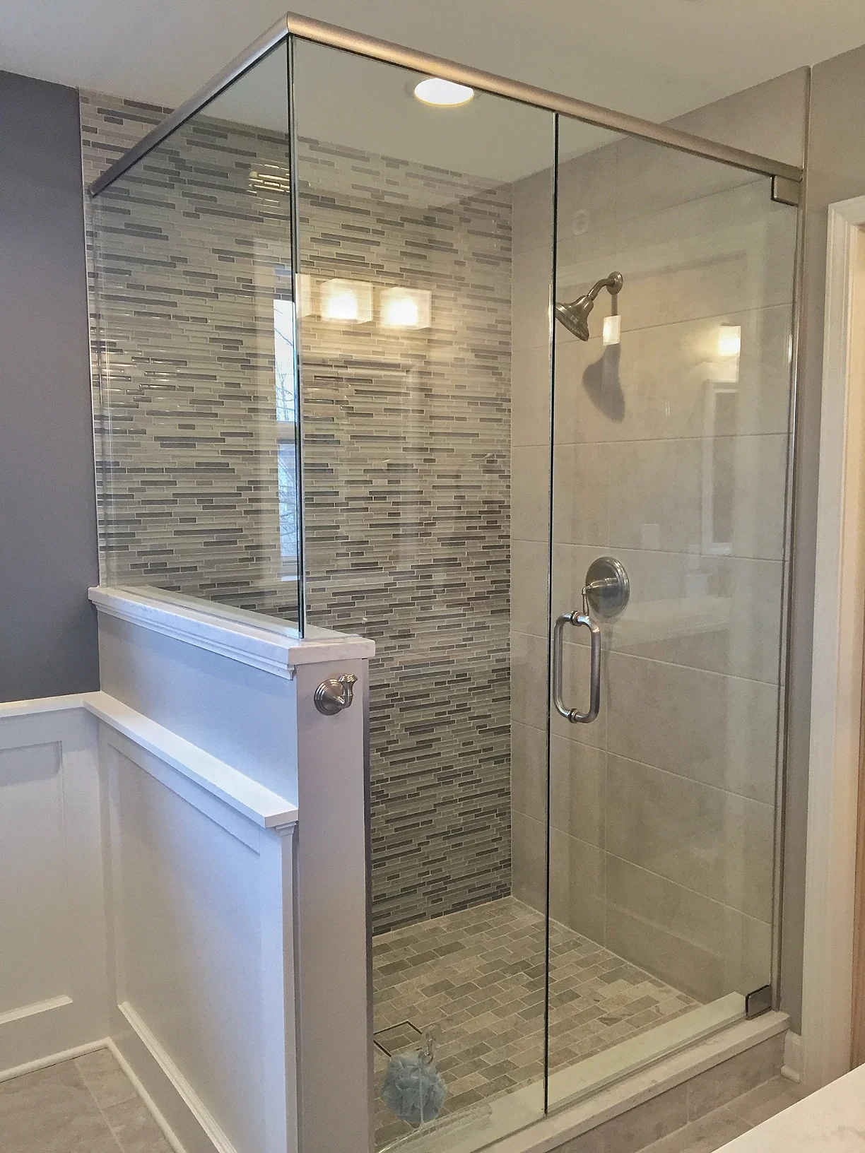 Large custom shower with accent wall and custom glass door by Hawthorn Development Hawthorn Woods, IL