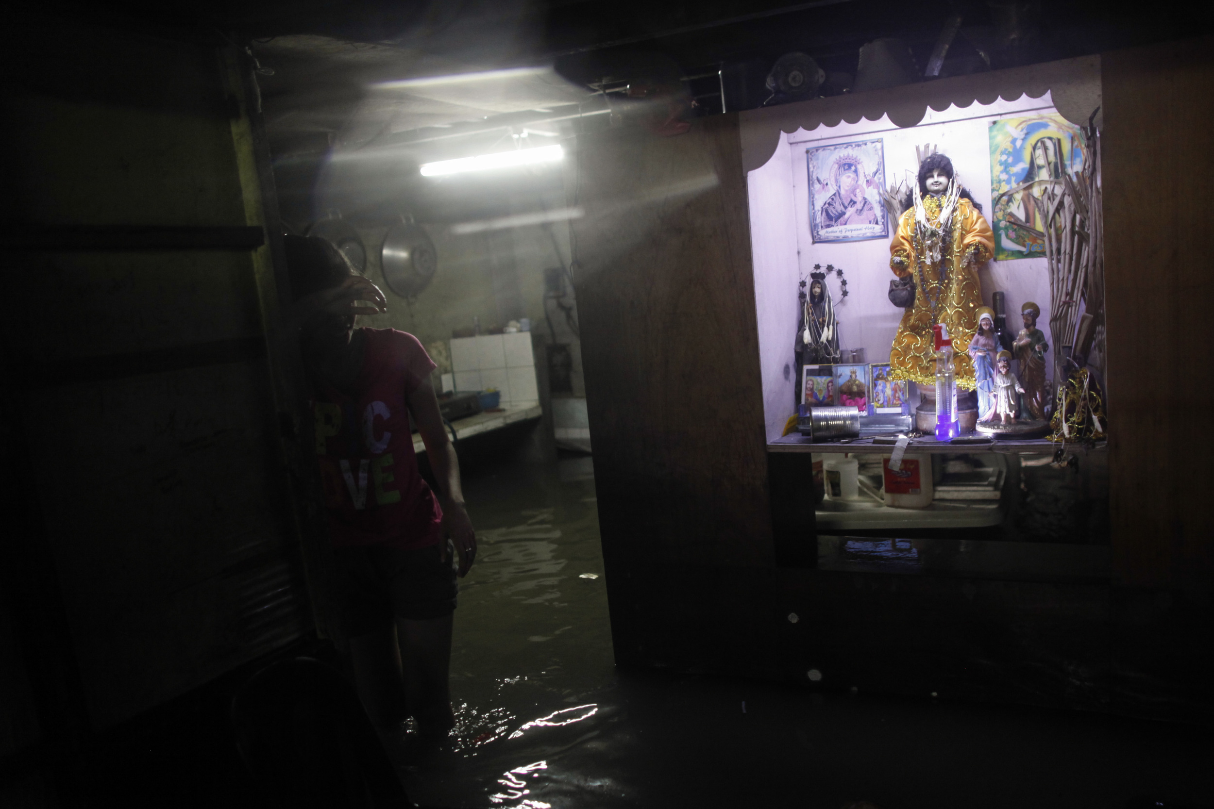 A resident takes a break from cleaning her house that was submerged in floodwaters caused by monsoon rains in Sucat, Paranaque south of Metro Manila August 19, 2013. Heavy rain in the Philippine capital forced the closure of government offices, scho