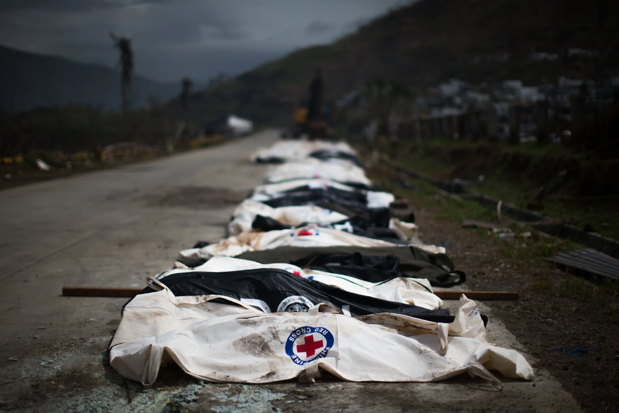  Cadavers are lined up to be buried in the mass burial site in Tacloban City   