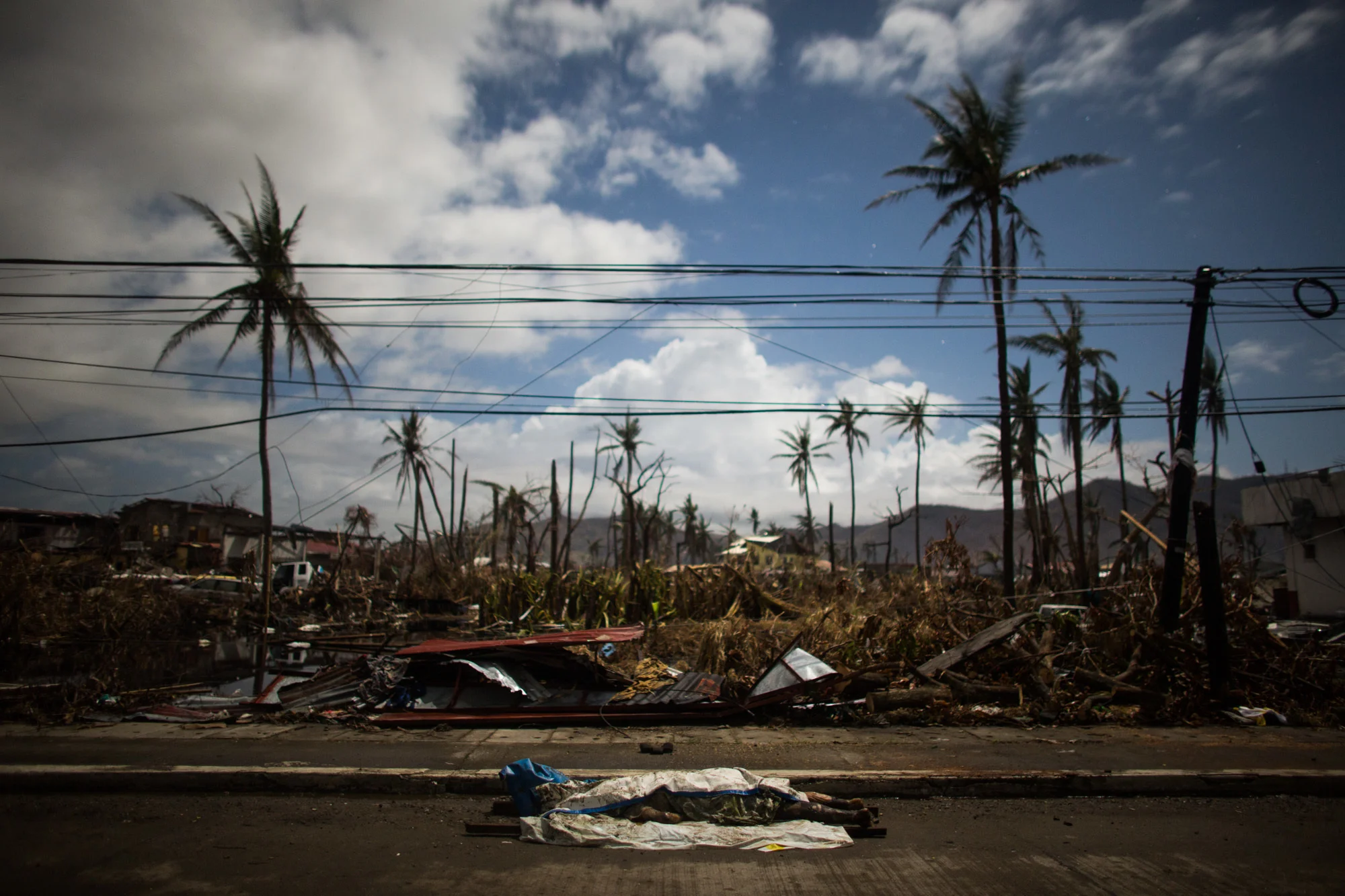  A cadaver of a victim that was found is left along the highway to be recovered in Tacloban City 