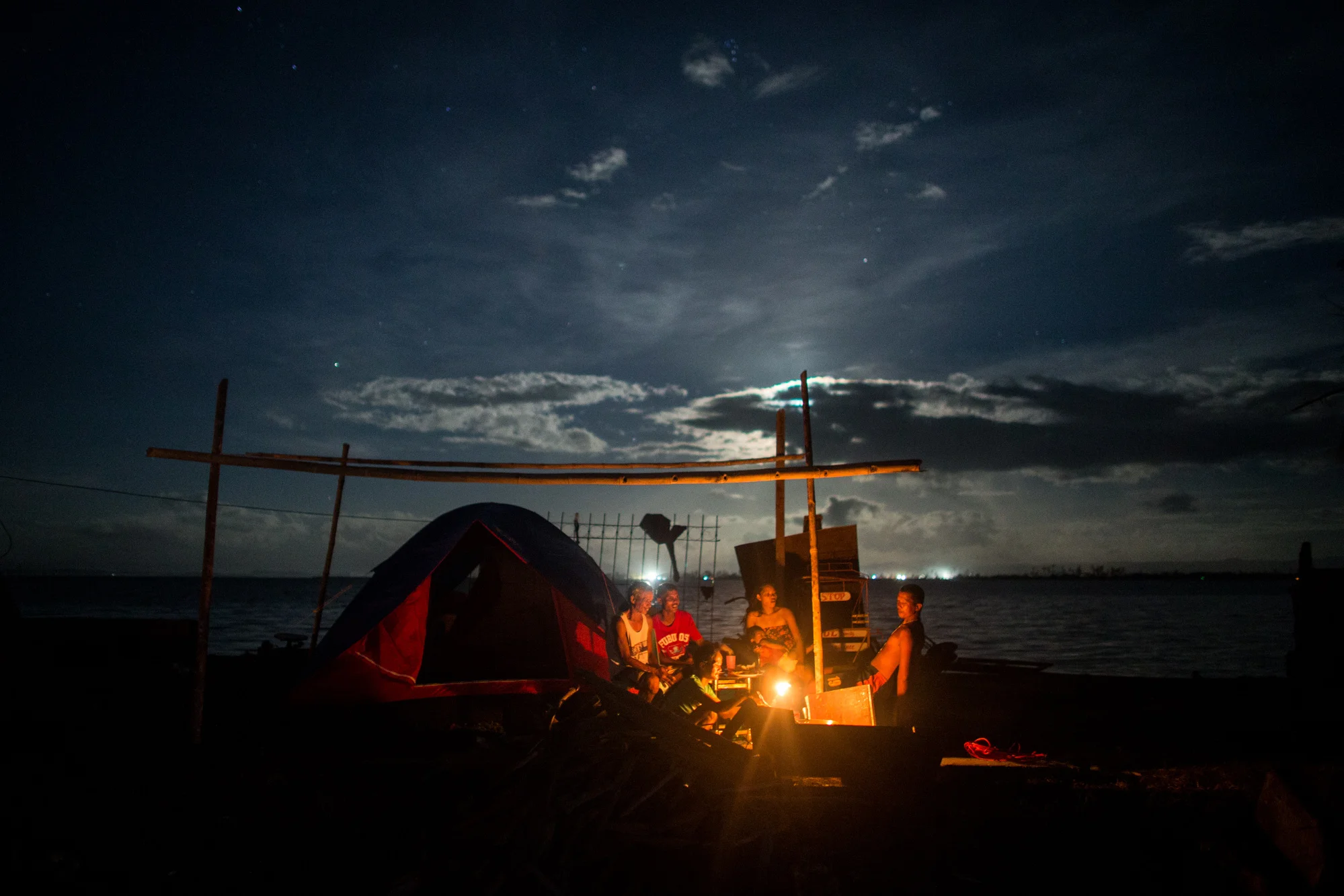  Survivors share a meal inside a tent that was brought by foreign NGOs as aid in Tacloban City    