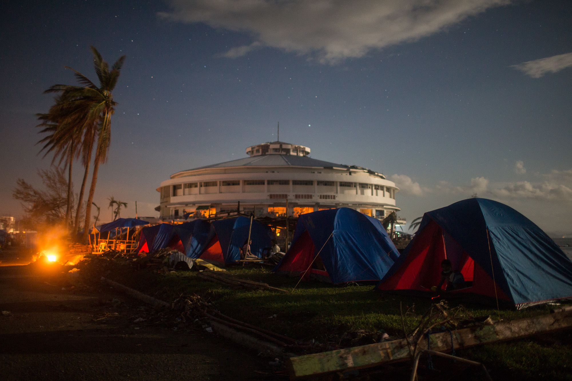 Survivors set up camp outside the sports stadium in Tacloban, Leyte.   