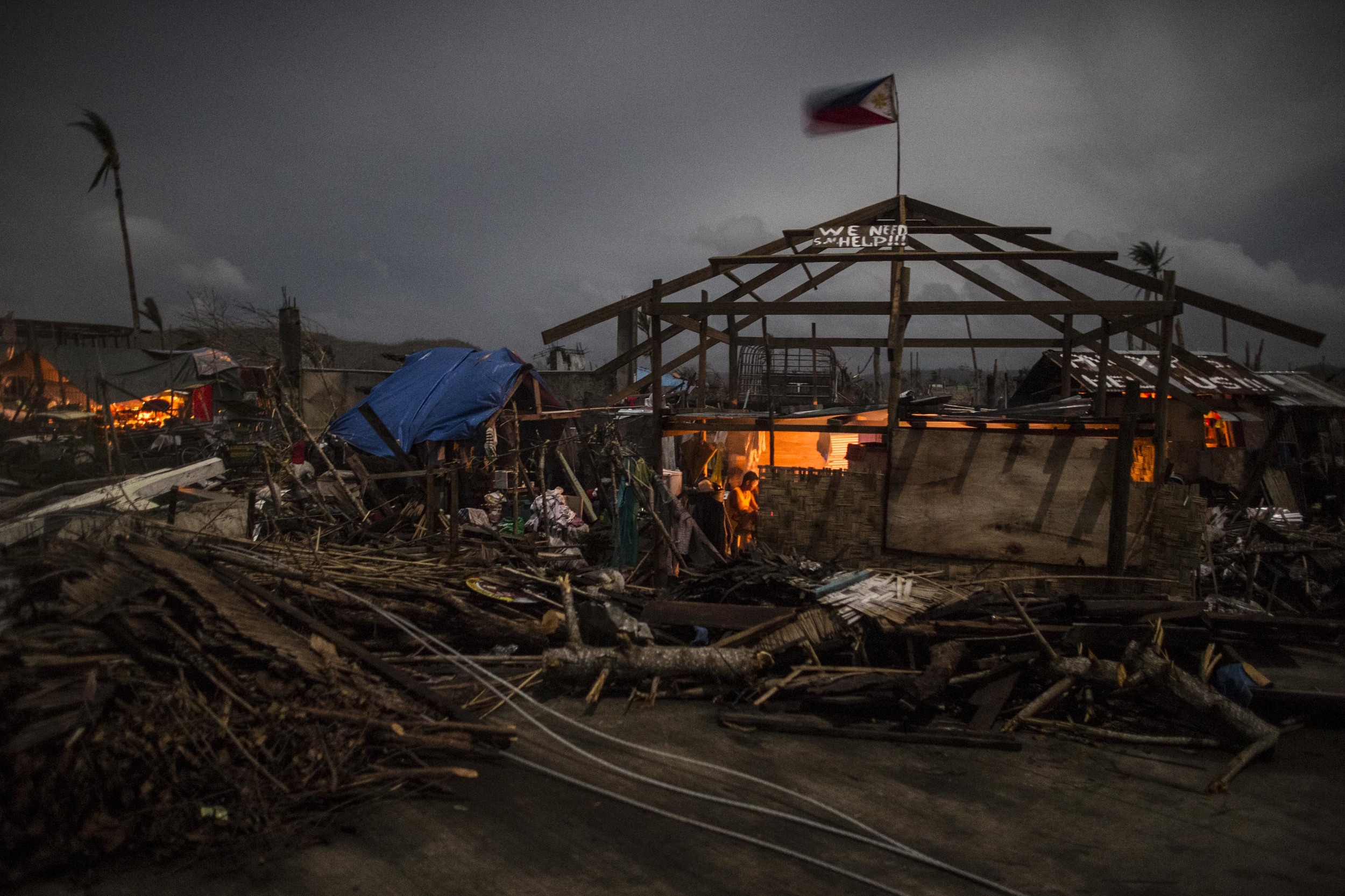  A survivor is seen inside his home that was damaged by typhoon Haiyan in Marabut, Samar.    