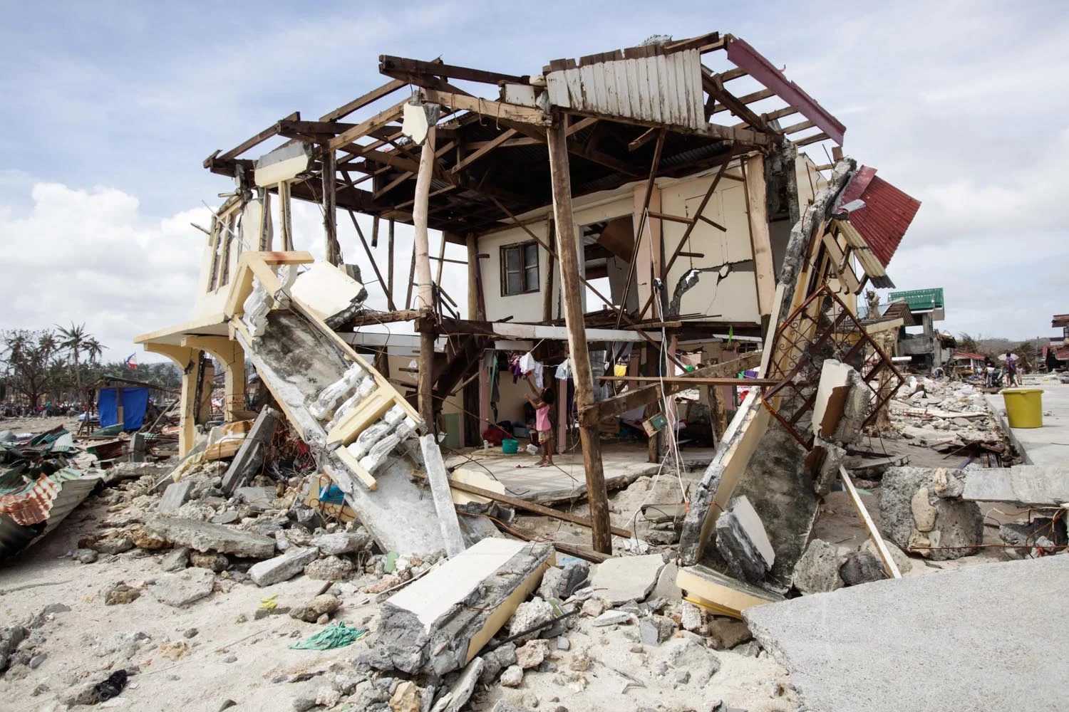  A survivor is seen inside her home that was destroyed by the effects of Typhoon Haiyan in Balangkayan, Eastern Samar 