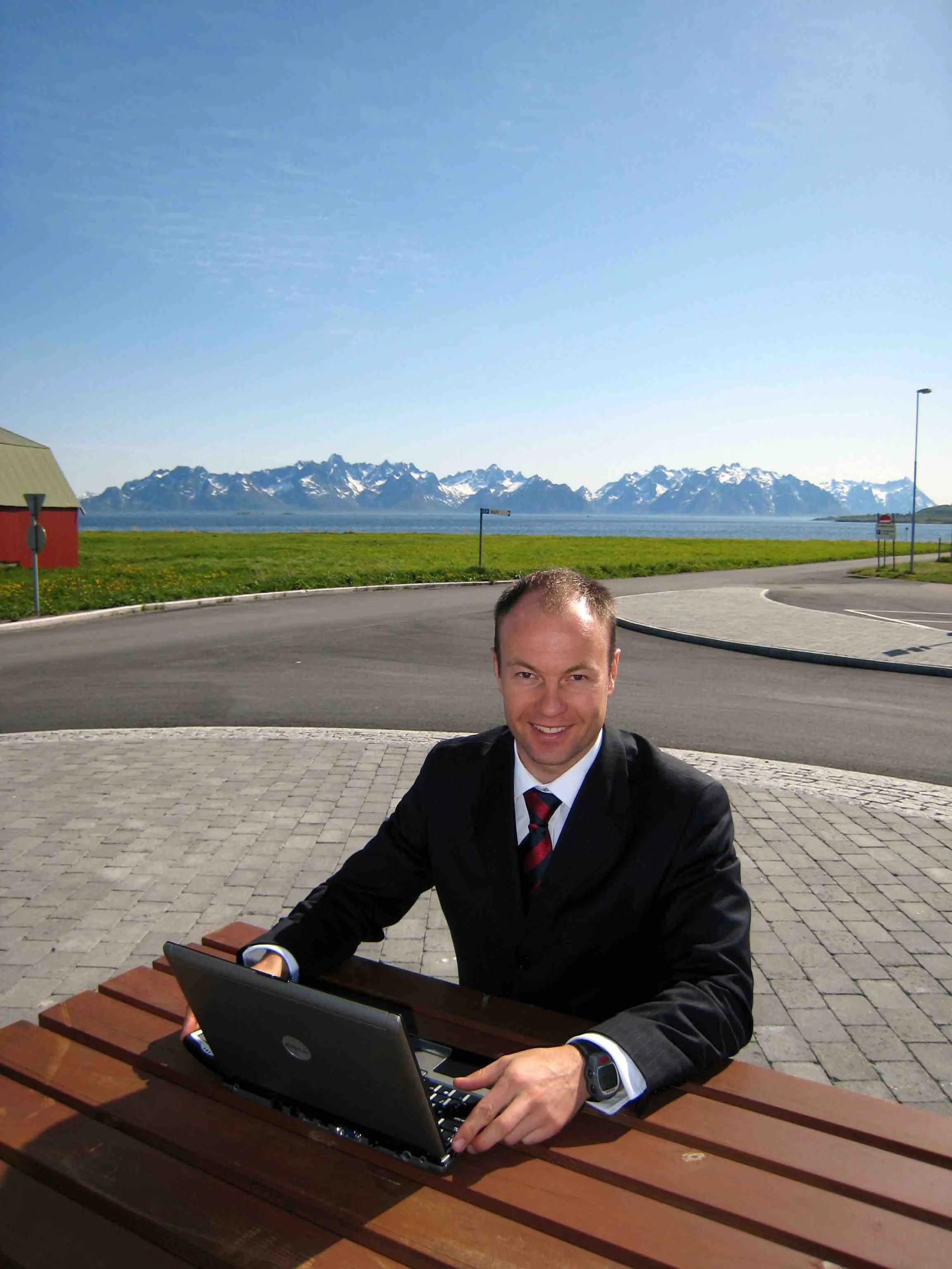 Founder - Keith, back when he had a little more hair and worked in Norway. Yes that's an unfashionable Polar watch on the left arm and a Blackberry in the right hand. This was the scene after the opening of the first Boots Chemist in the Arctic Circle. That's the Lofoten Wall in the background. Norway is beautiful, you should visit. Back then Blackberrys had 5 DAYS battery life.