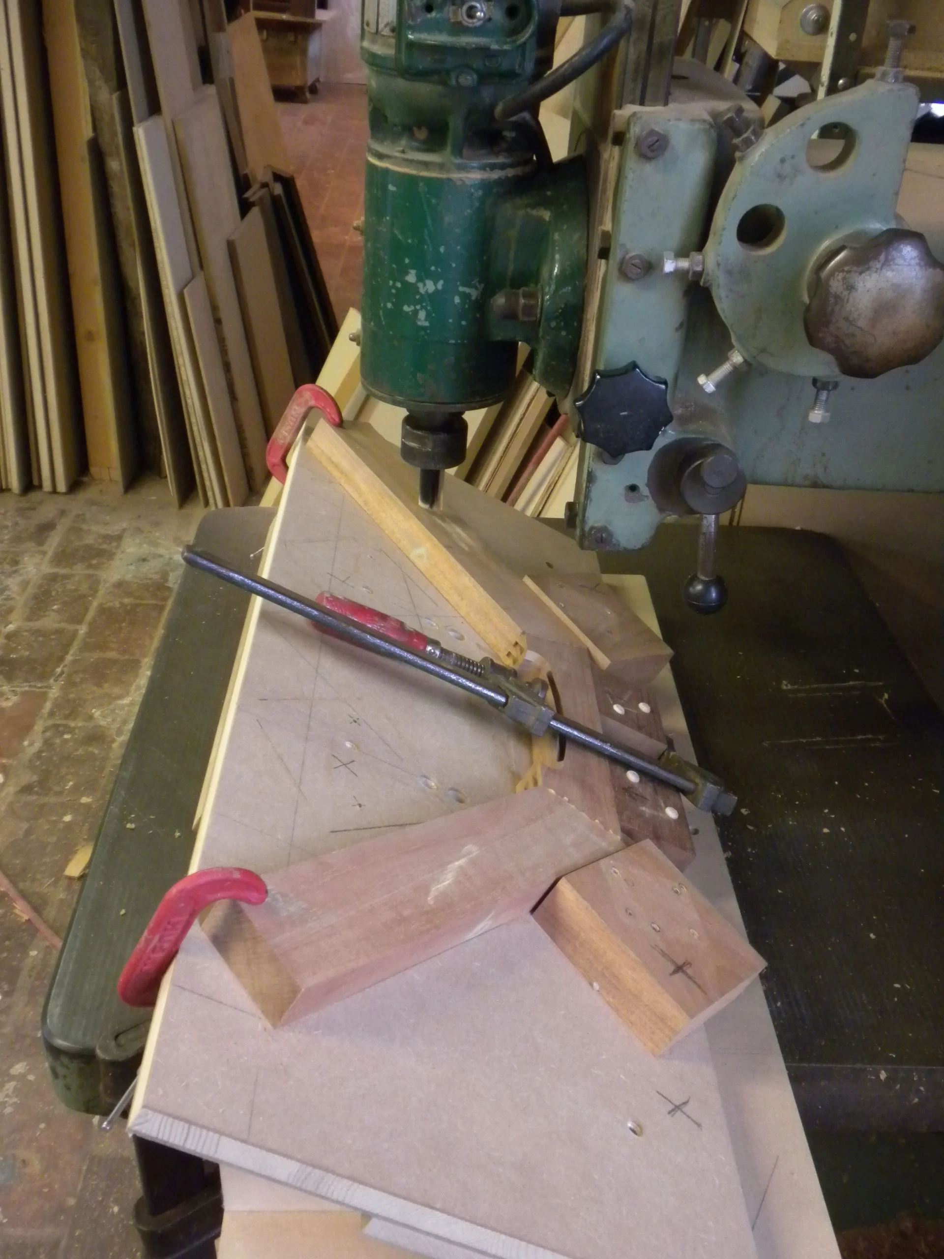   With the overhead vertical, the crest rail is on an angle to cut the holes for the back legs.     